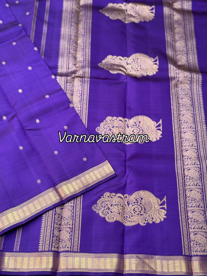 An elegant small border purple blue shade kanchivaram silk saree with star kamalam