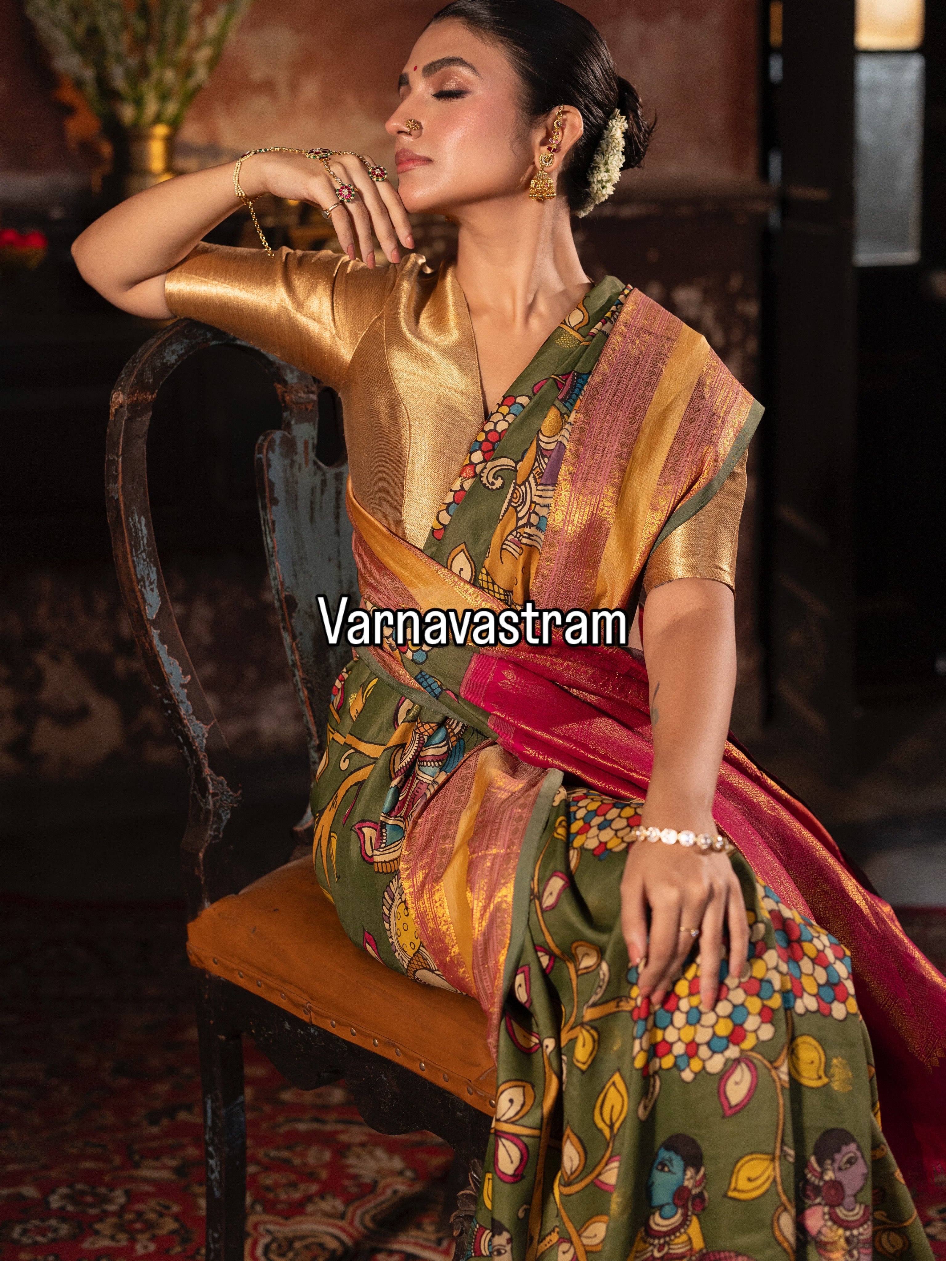 A beautiful and traditional korvai kanchivaram silk saree adorned with forest green base , dancing apsaras and floral creepers Handdrawn handpainted penkalamkari