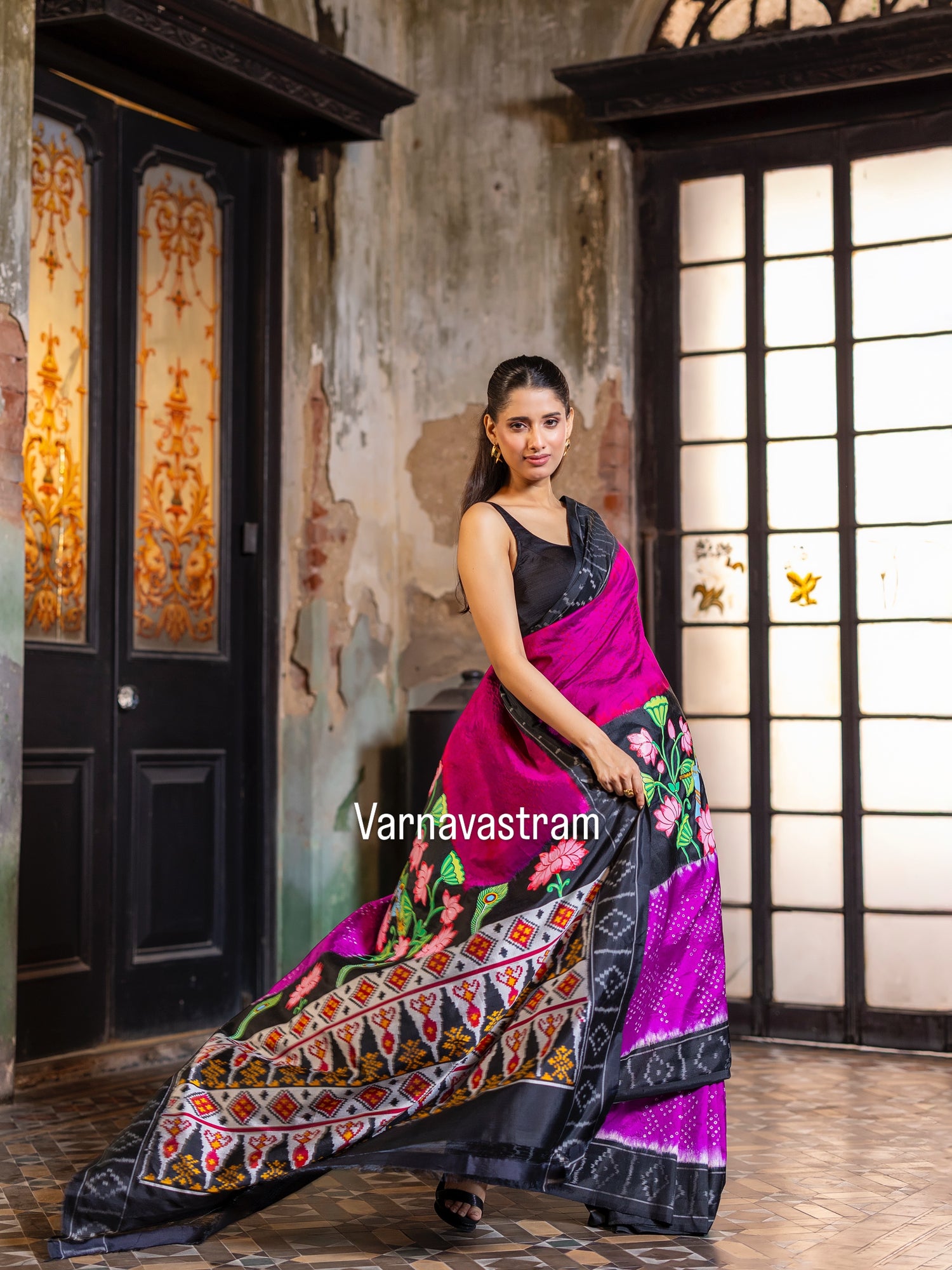 An elegant fusion crafted mulberry silk ikkat saree adorned with pichwai handpainted and tie dyed Bhandej