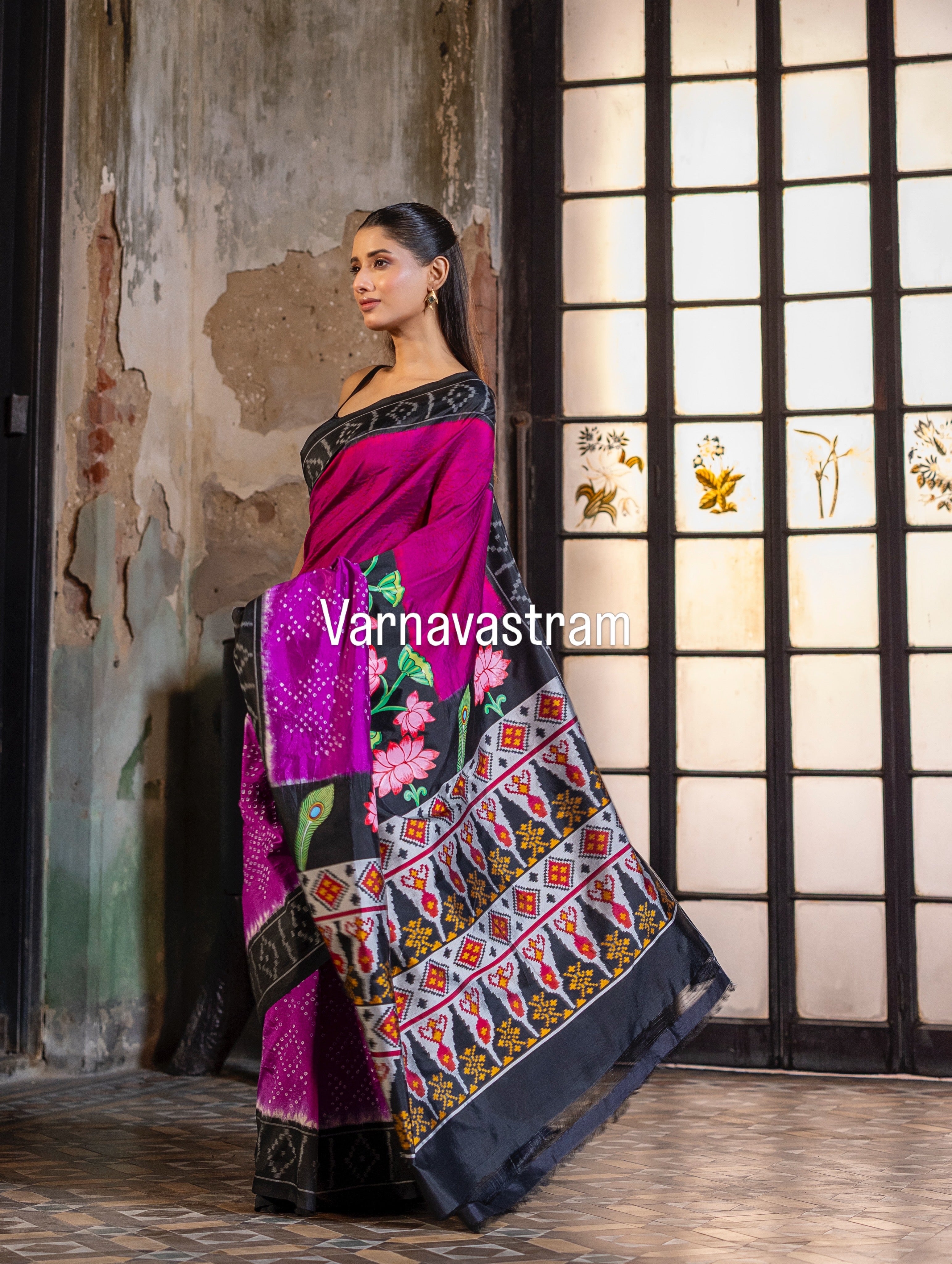An elegant fusion crafted mulberry silk ikkat saree adorned with pichwai handpainted and tie dyed Bhandej