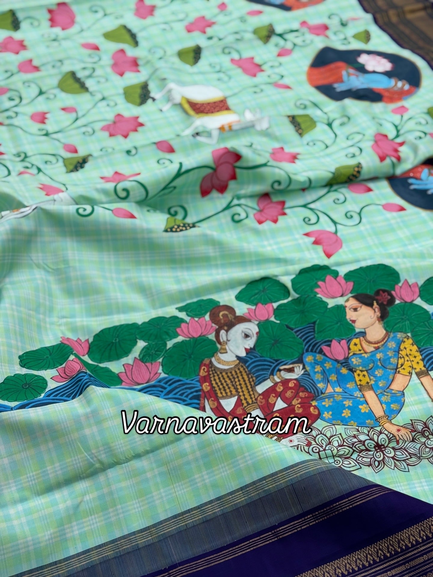 A stunner kanchivaram kattam korvai silk saree with foam green adorned with Handdrawn handpainted pichwai artwork