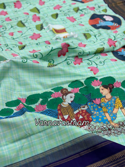 A stunner kanchivaram kattam korvai silk saree with foam green adorned with Handdrawn handpainted pichwai artwork