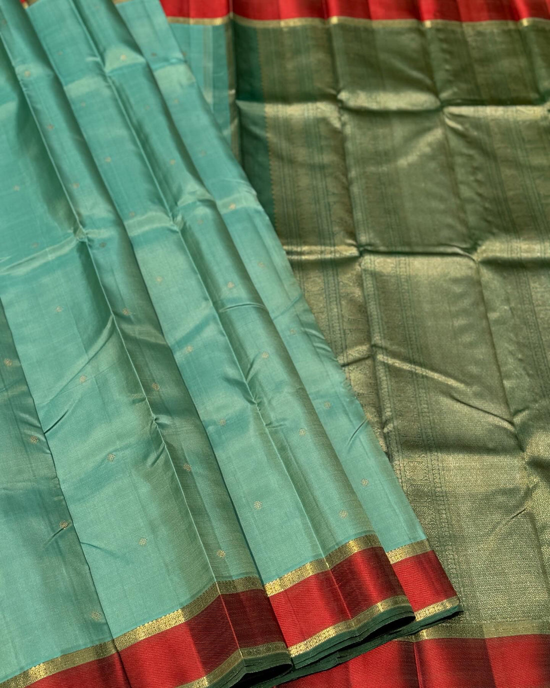 A gorgeous cyan green with red threadwork and zari border kanchivaram silk SAREE