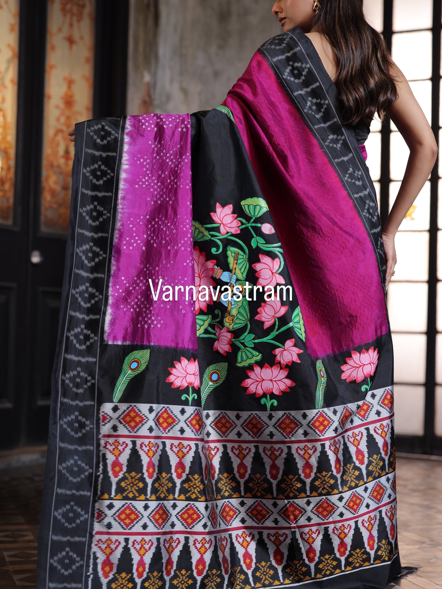 An elegant fusion crafted mulberry silk ikkat saree adorned with pichwai handpainted and tie dyed Bhandej