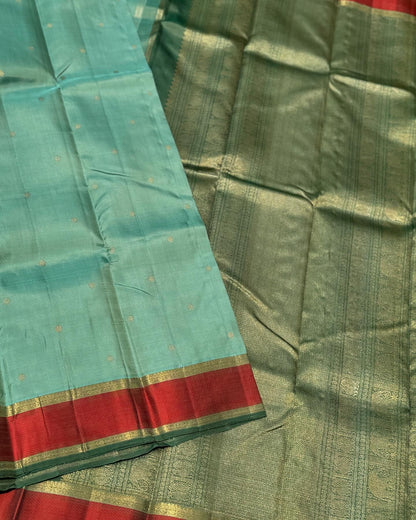 A gorgeous cyan green with red threadwork and zari border kanchivaram silk SAREE