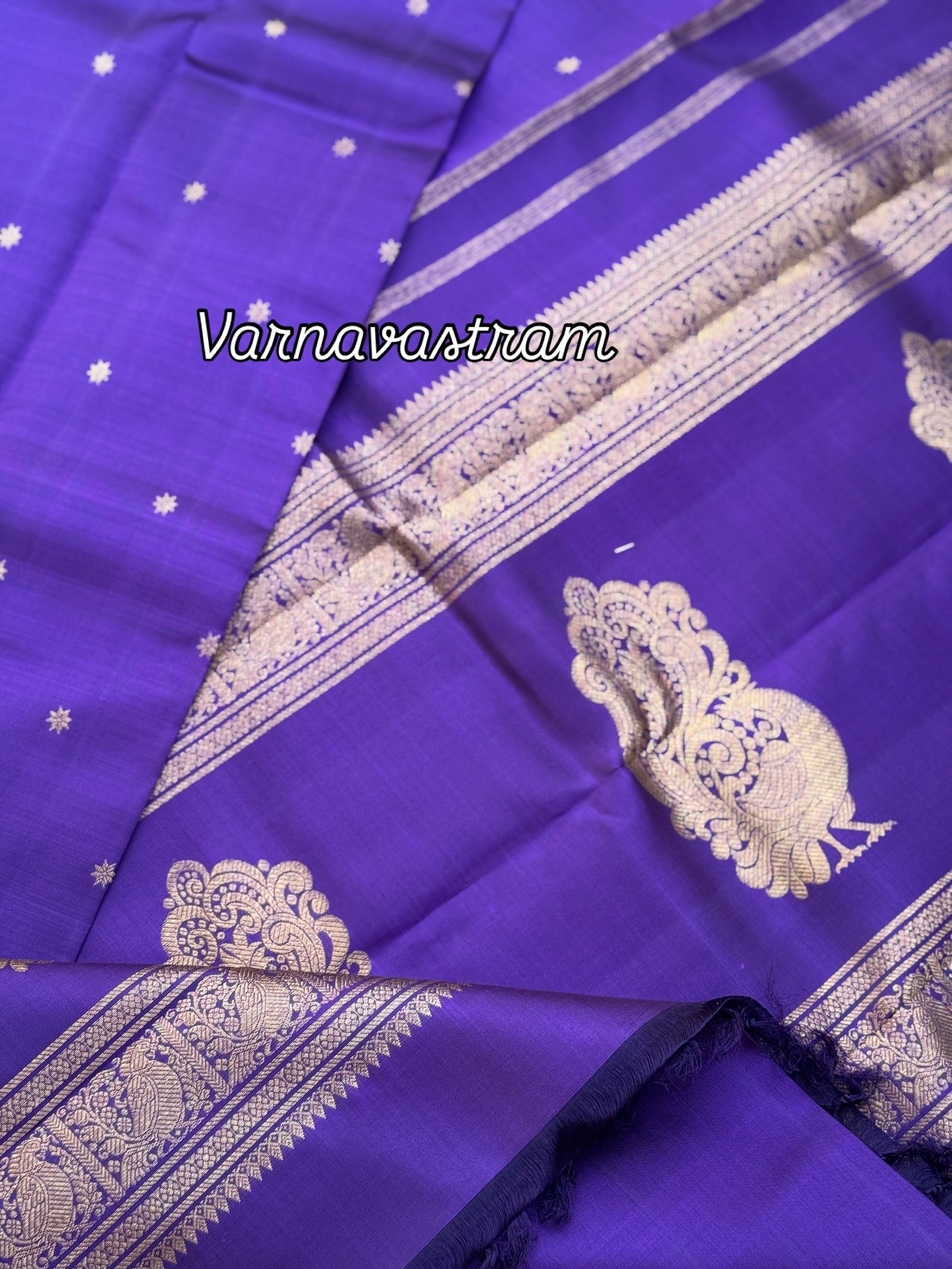 An elegant small border purple blue shade kanchivaram silk saree with star kamalam