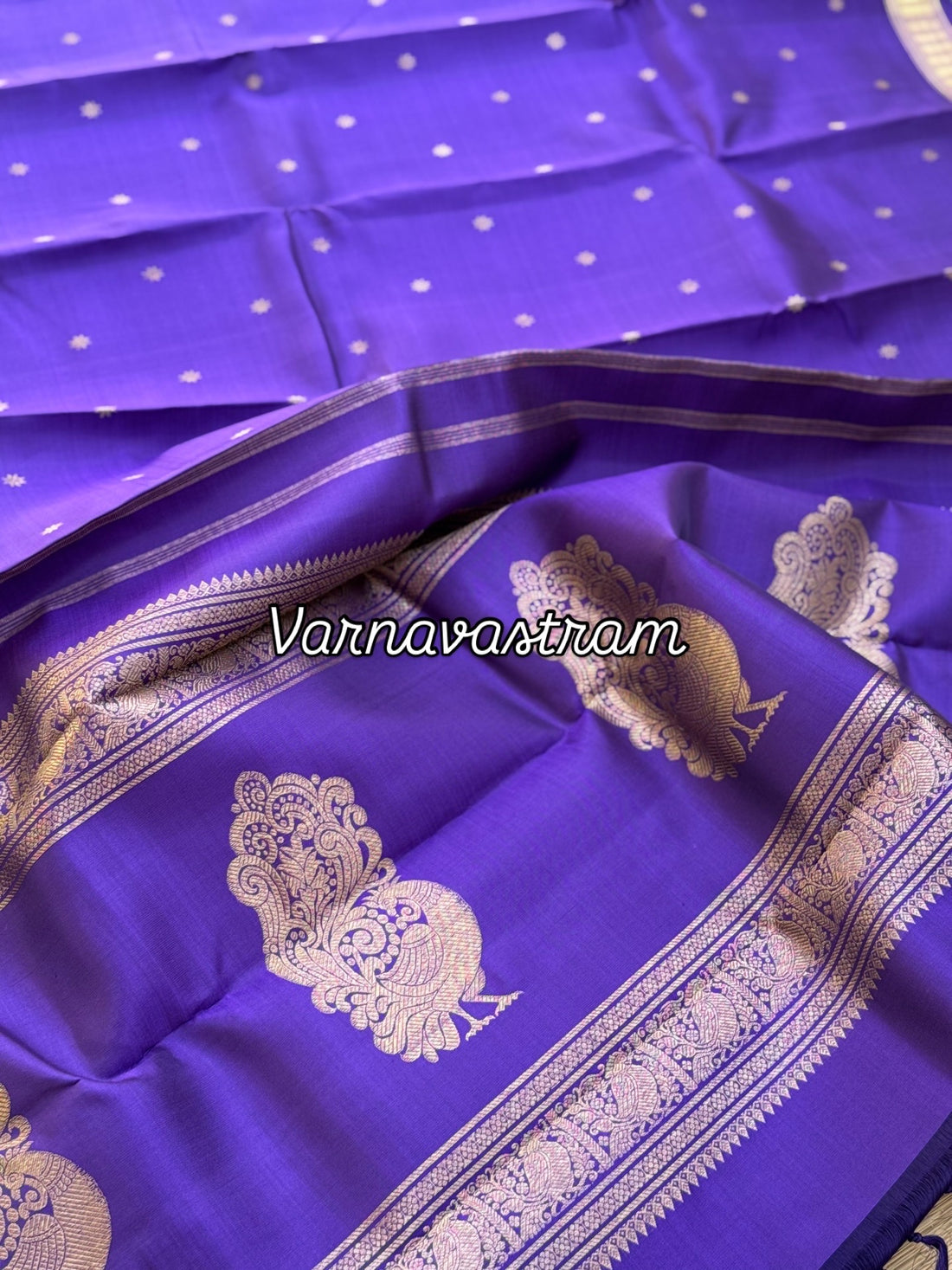 An elegant small border purple blue shade kanchivaram silk saree with star kamalam