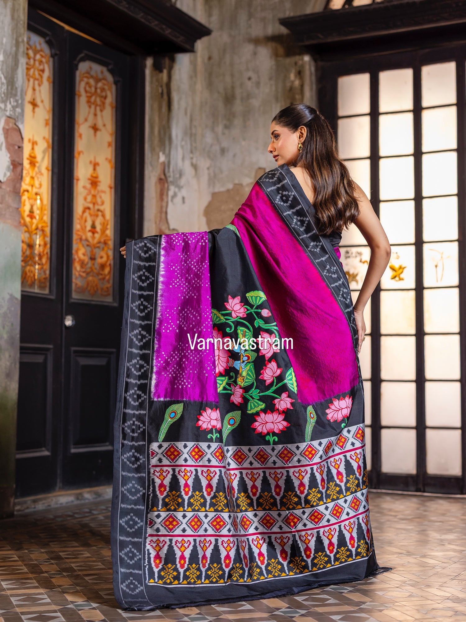 An elegant fusion crafted mulberry silk ikkat saree adorned with pichwai handpainted and tie dyed Bhandej