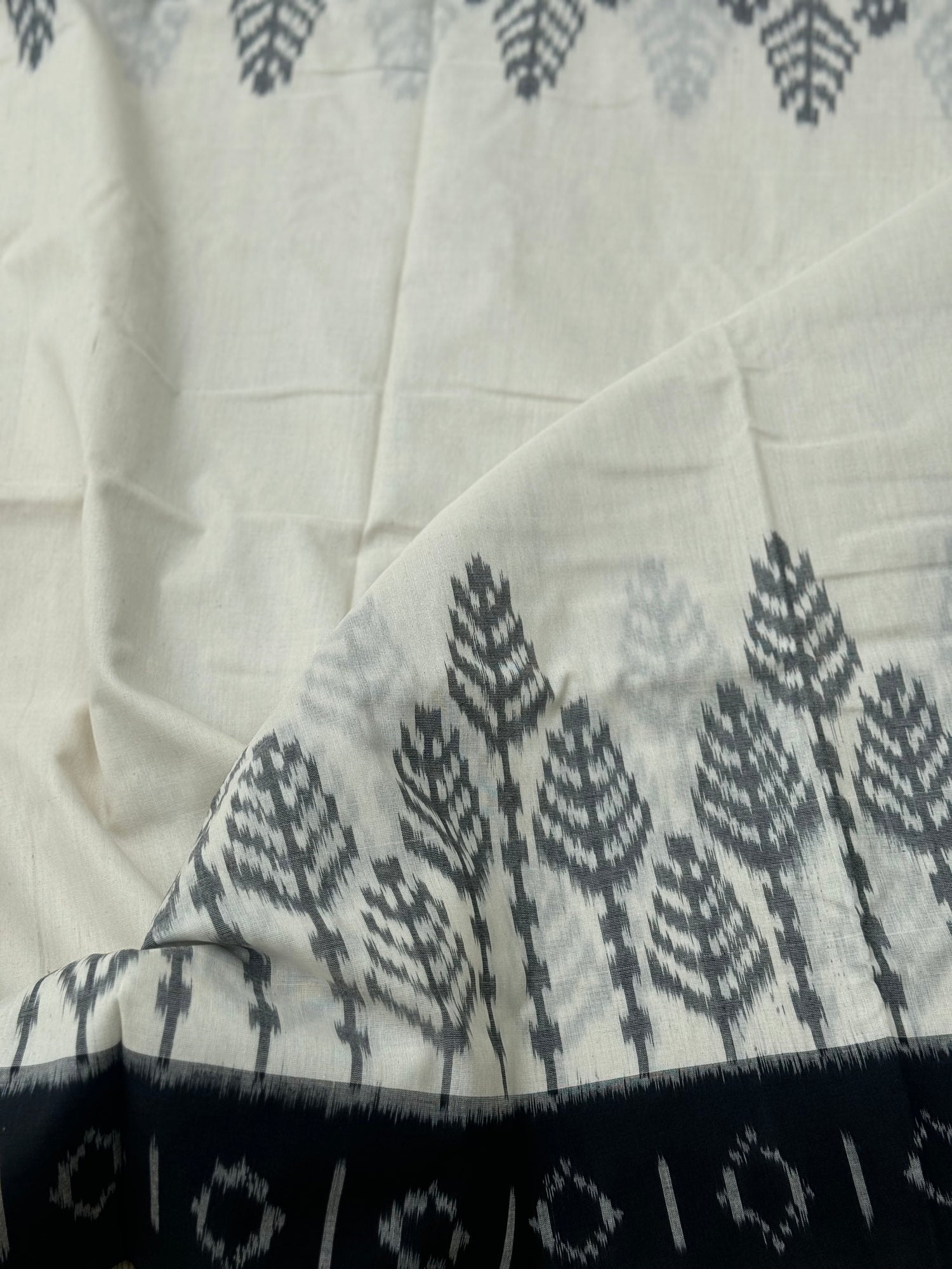 Ivory and  black handwoven weft single ikkat cotton saree