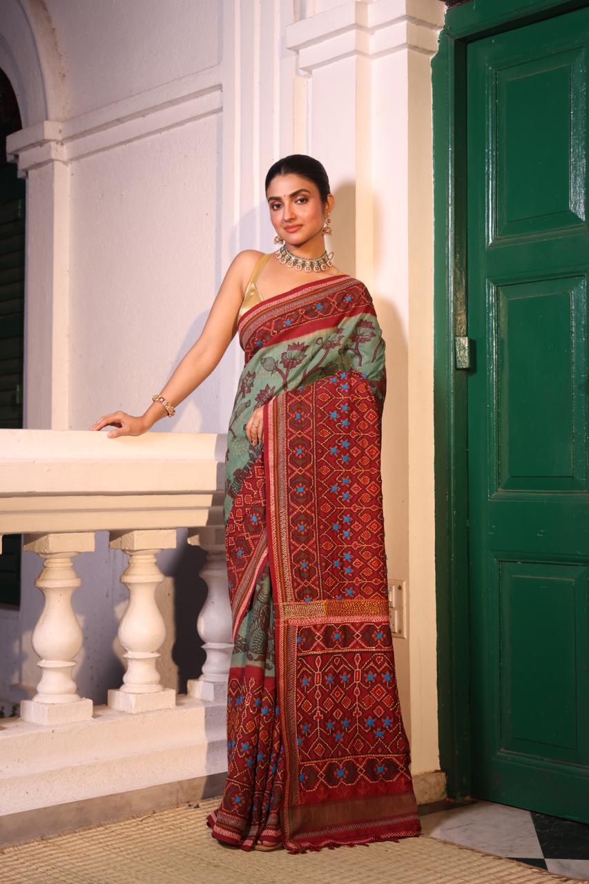 Handdrawn handpainted penkalamkari on handknotted Bhandej body with Katha handembroidery on a patola silk ikkat saree