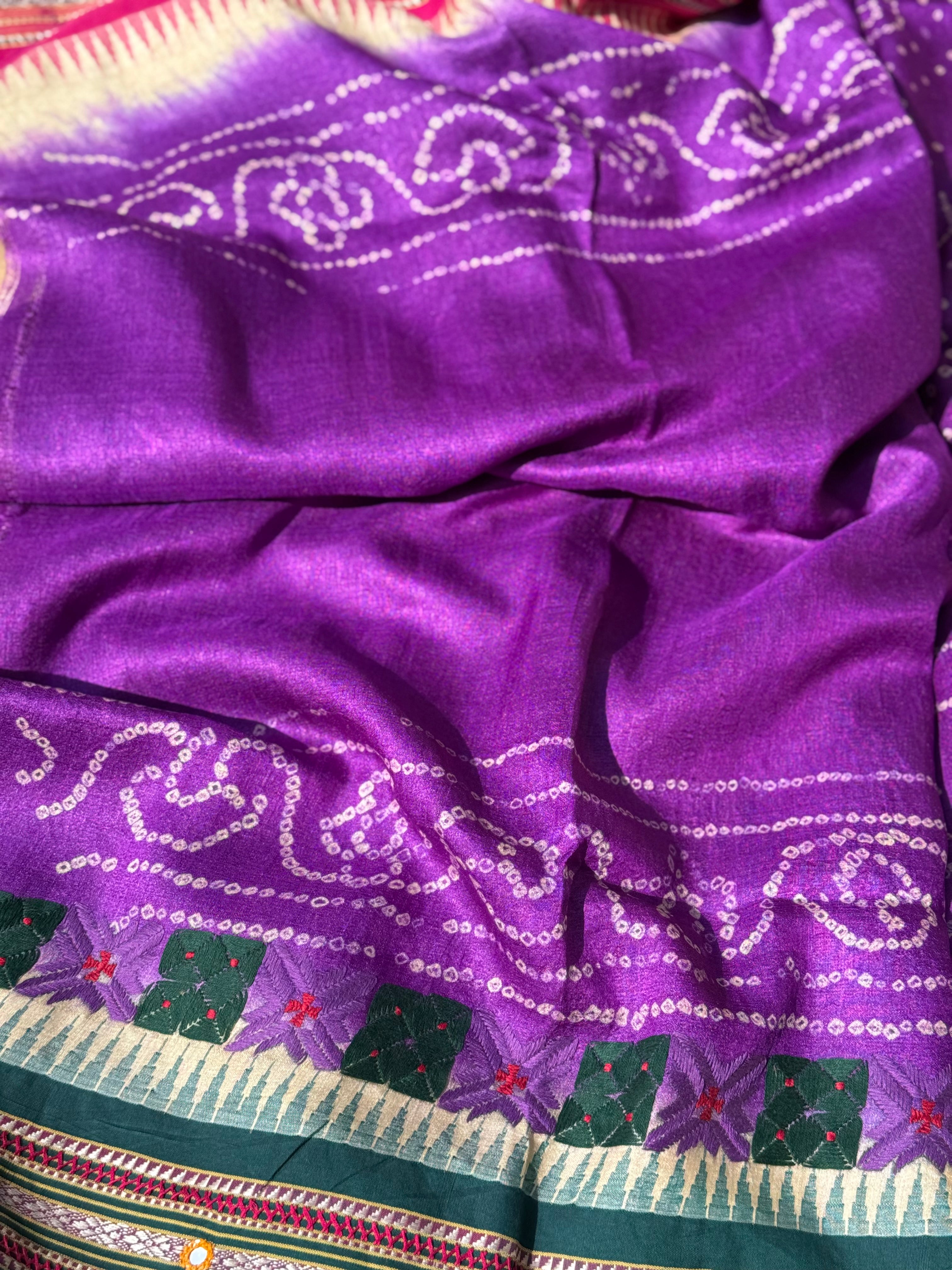 An exquisite handwoven vidharbha tussar silk saree with karvati kinar border intricately tie dyed with brinjal purple blue bhandhej and phulkari hand embroidered