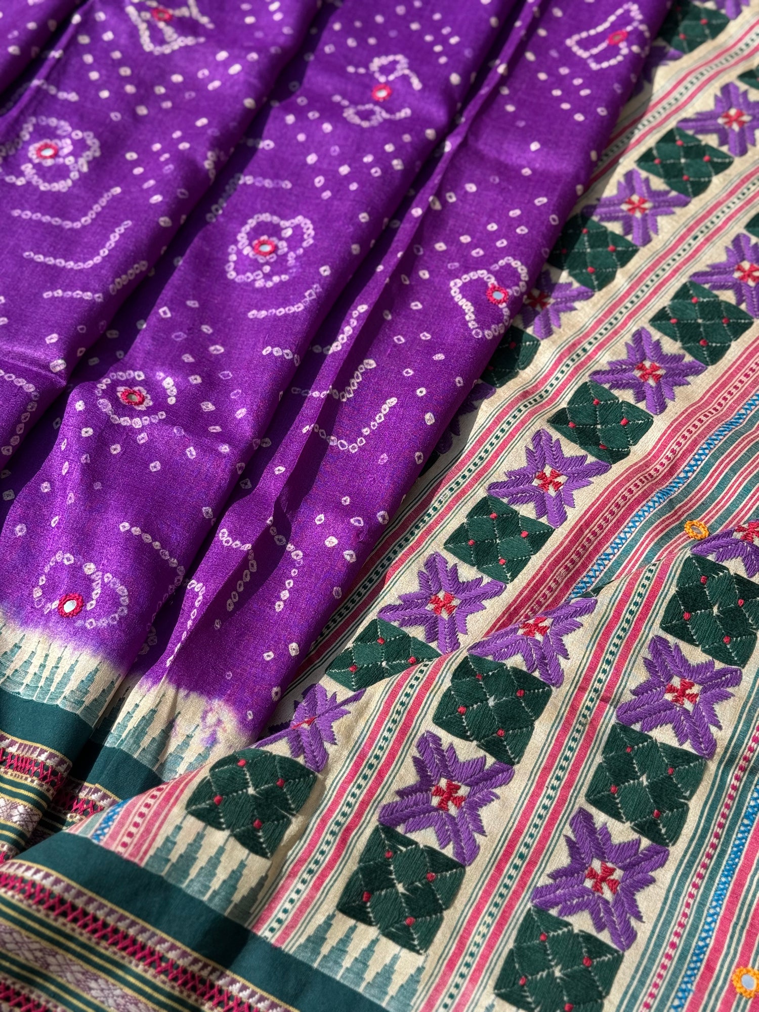 An exquisite handwoven vidharbha tussar silk saree with karvati kinar border intricately tie dyed with brinjal purple blue bhandhej and phulkari hand embroidered