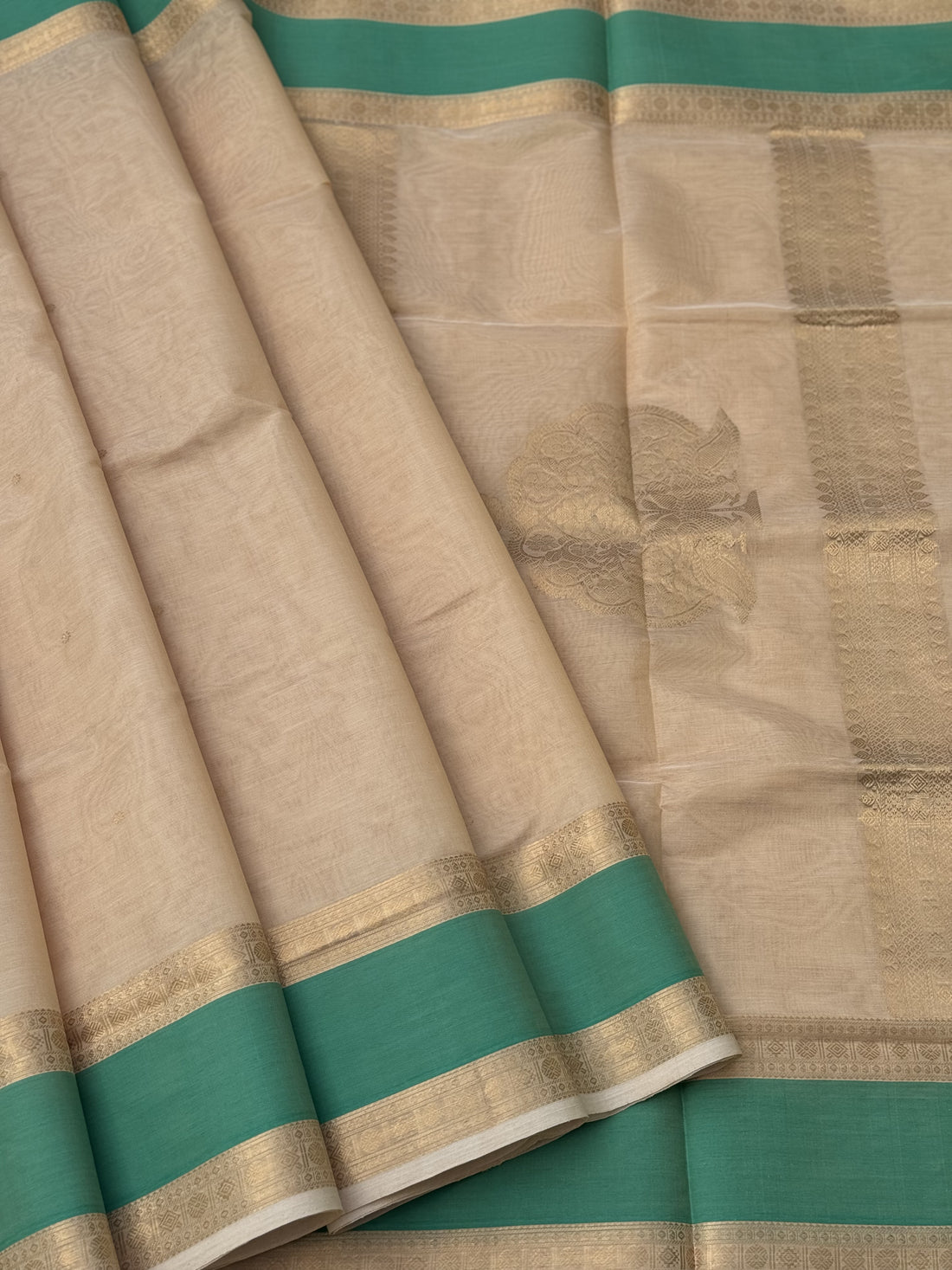 A gorgeous ivory gold shade handwoven Kanchi silk cotton saree