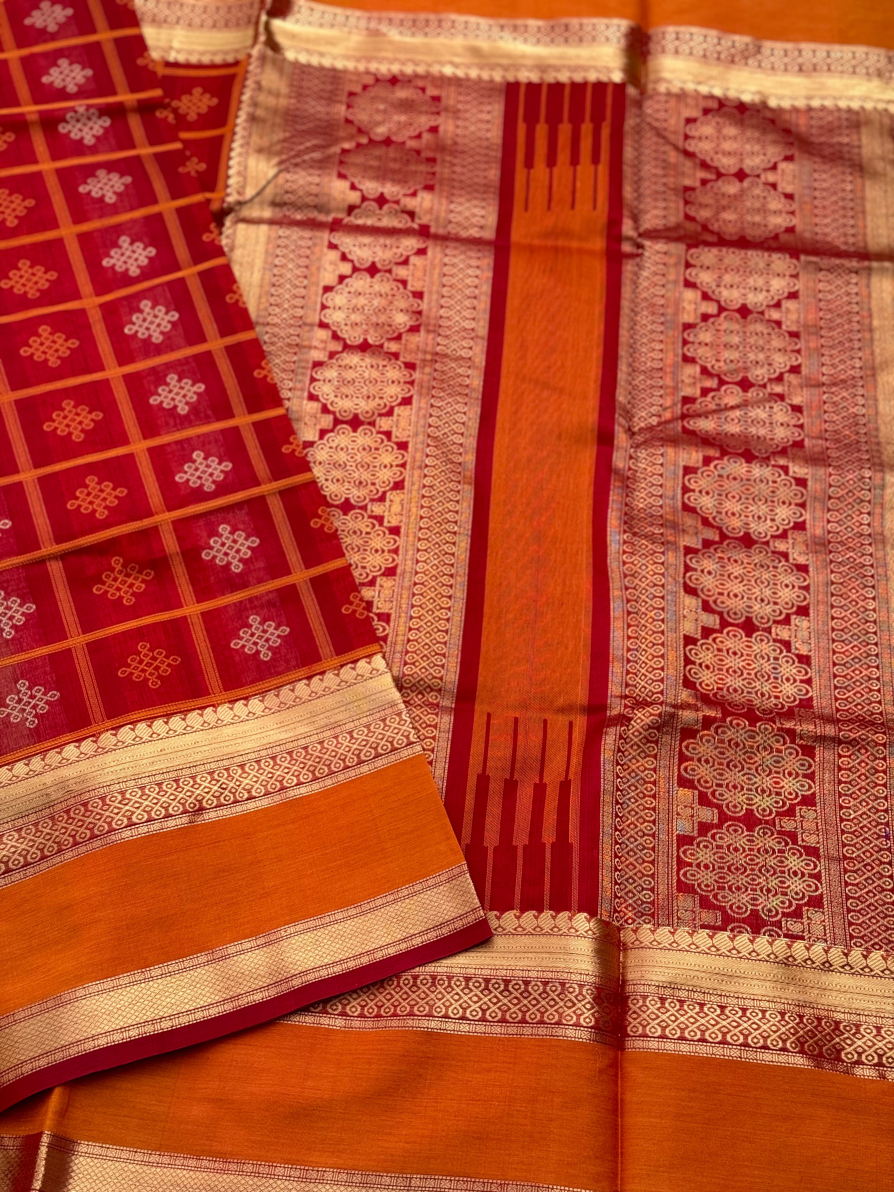 A gorgeous red shade handwoven Kolam motifs silk cotton saree