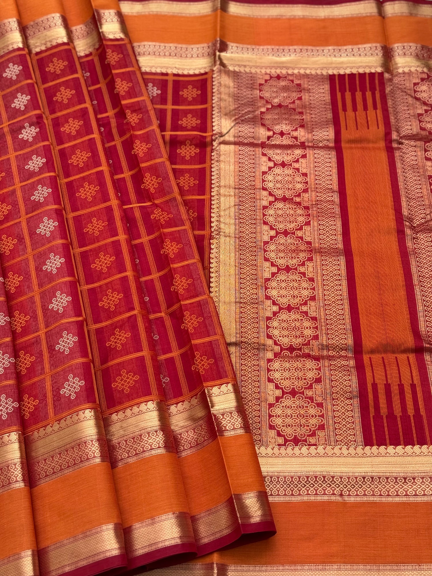 A gorgeous red shade handwoven Kolam motifs silk cotton saree