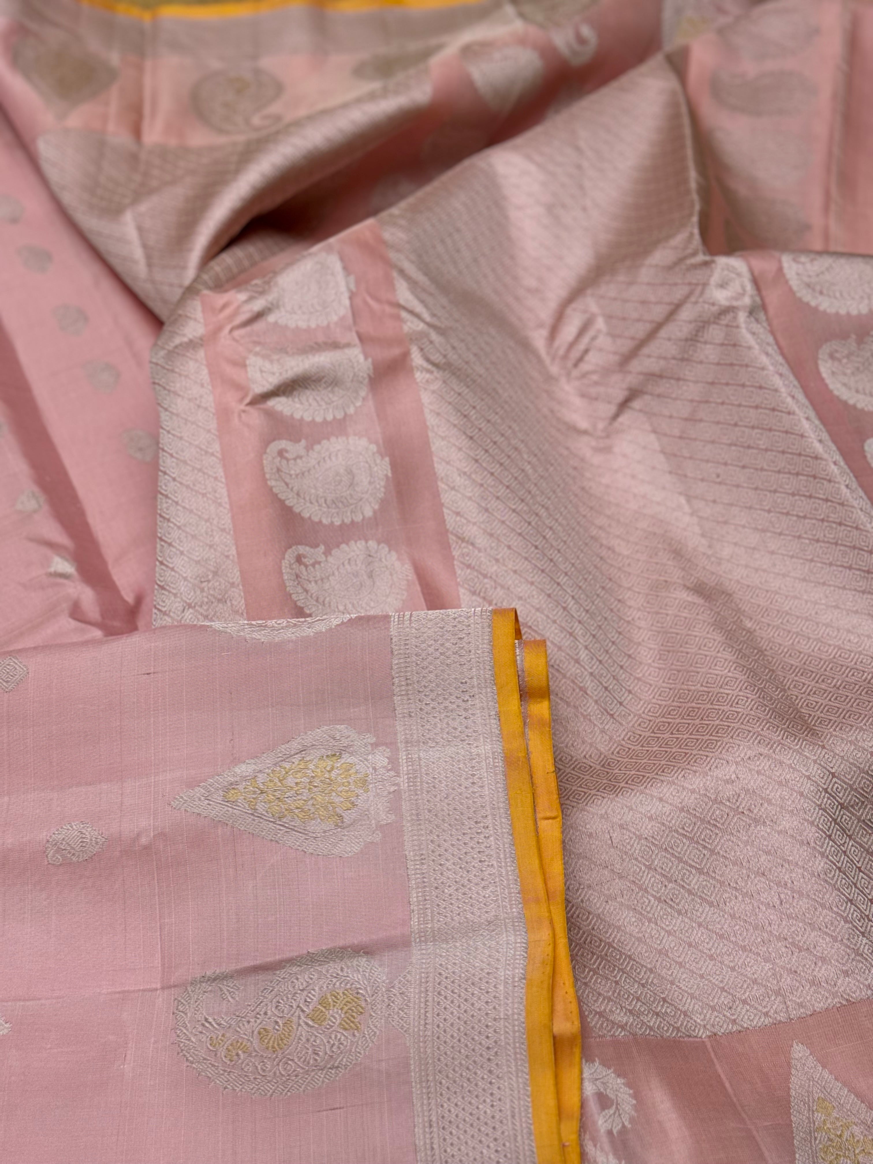 A gorgeous pastel baby pink with orange yellow handwoven gadwal silk saree