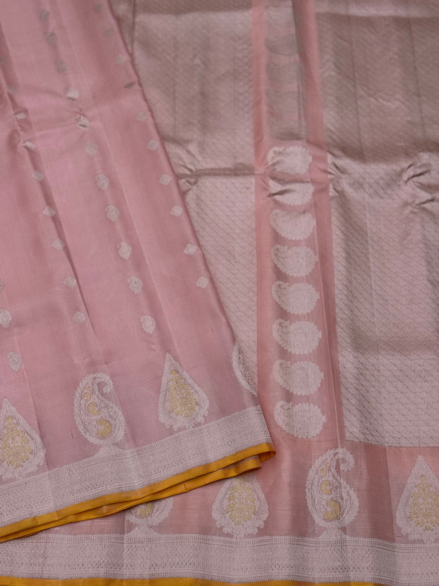 A gorgeous pastel baby pink with orange yellow handwoven gadwal silk saree