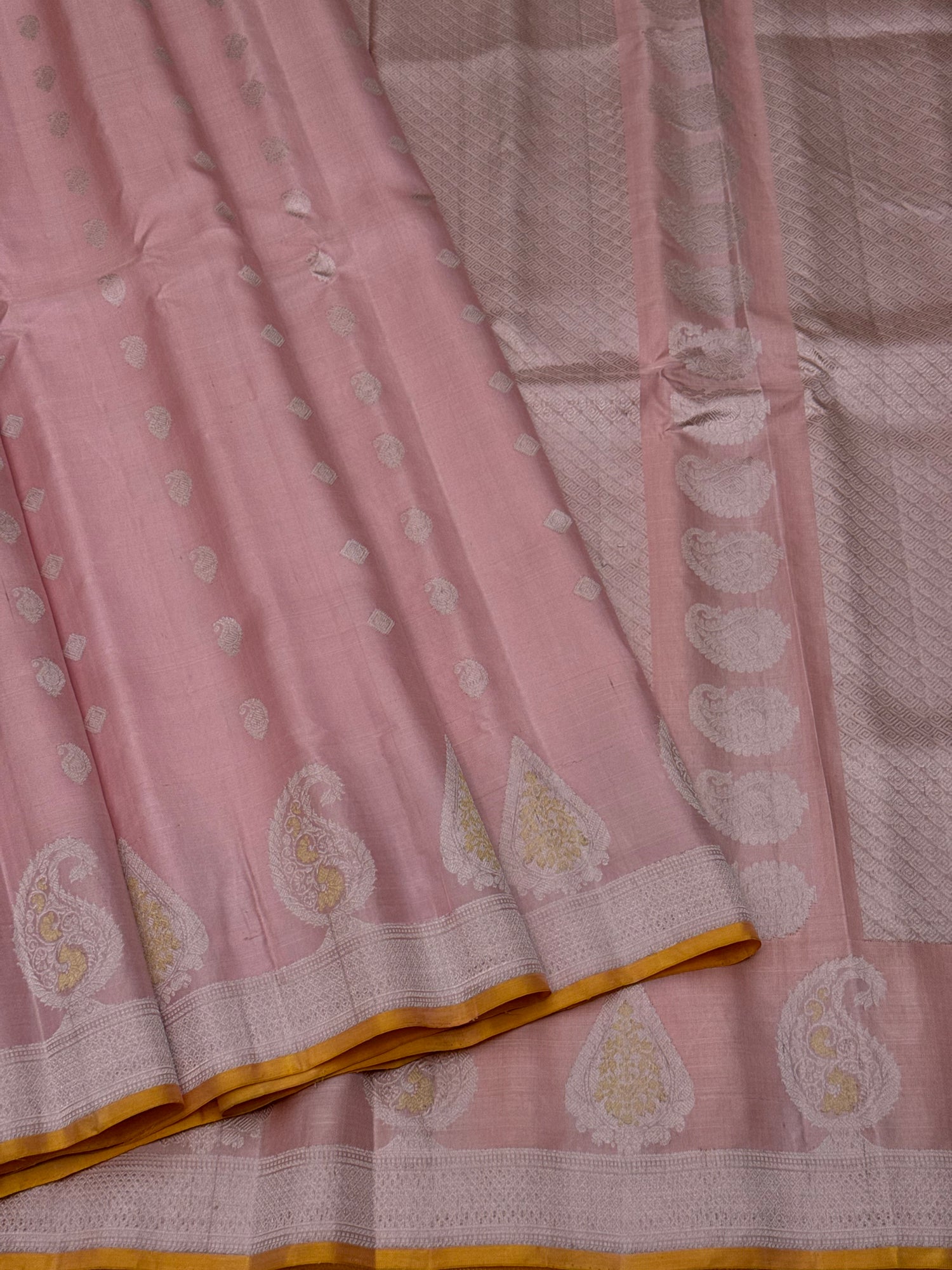 A gorgeous pastel baby pink with orange yellow handwoven gadwal silk saree