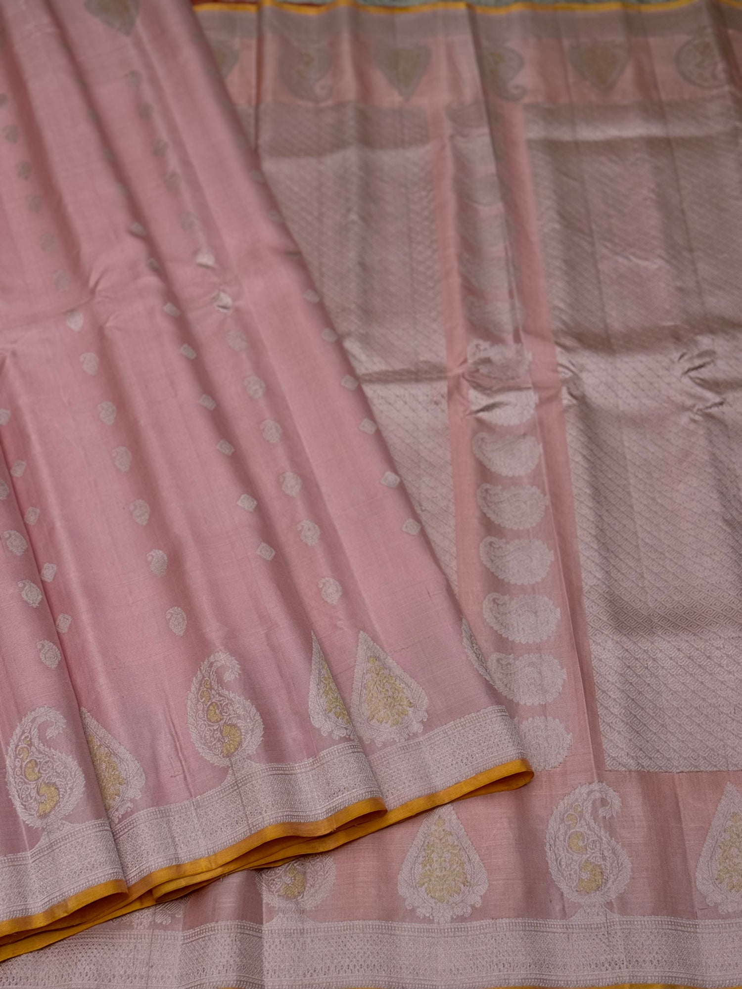 A gorgeous pastel baby pink with orange yellow handwoven gadwal silk saree