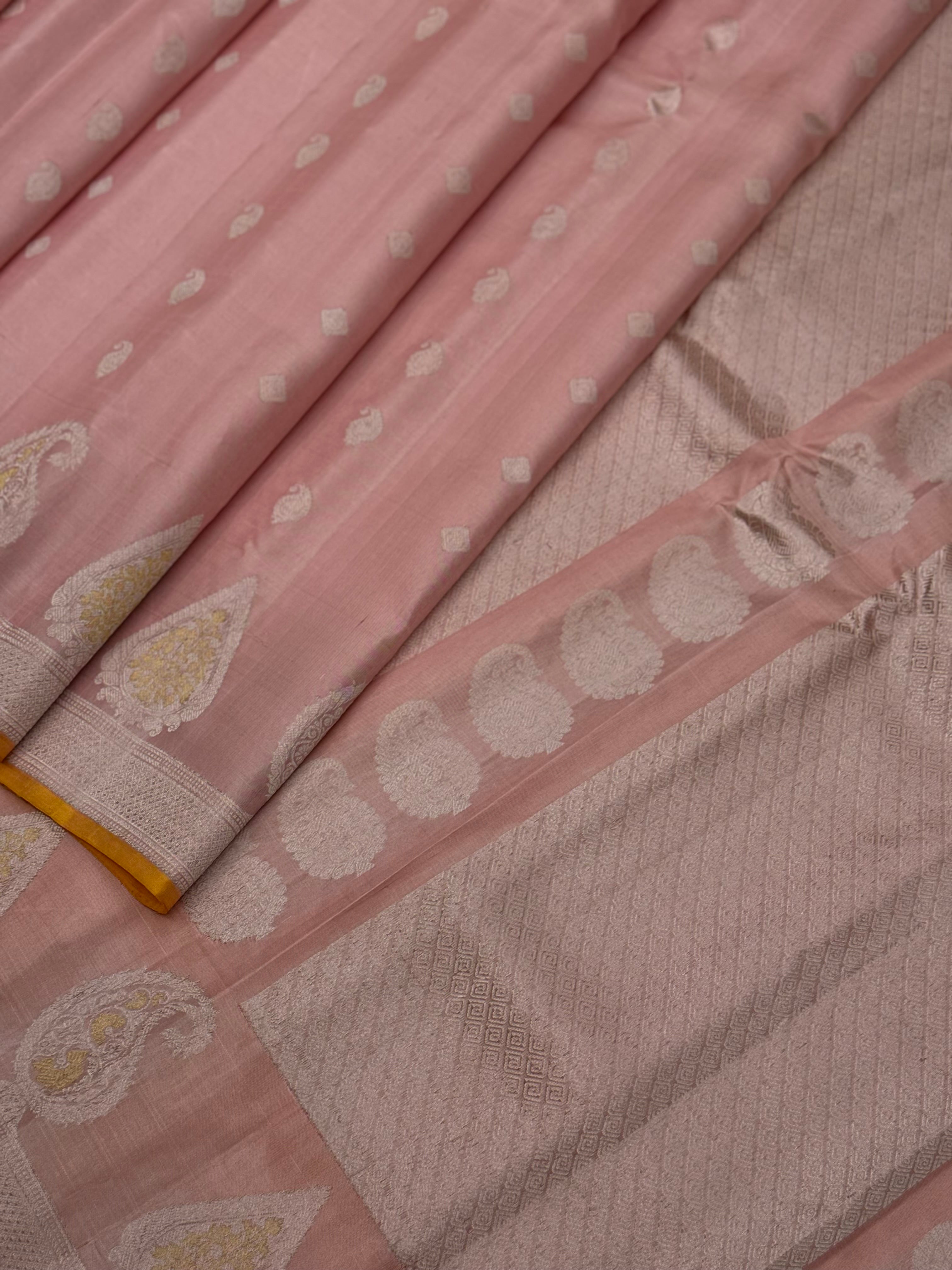 A gorgeous pastel baby pink with orange yellow handwoven gadwal silk saree