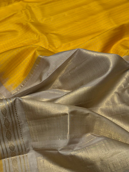 gorgeous offwhite with sunset yellow striped temple border kuttu handwoven gadwal silk saree