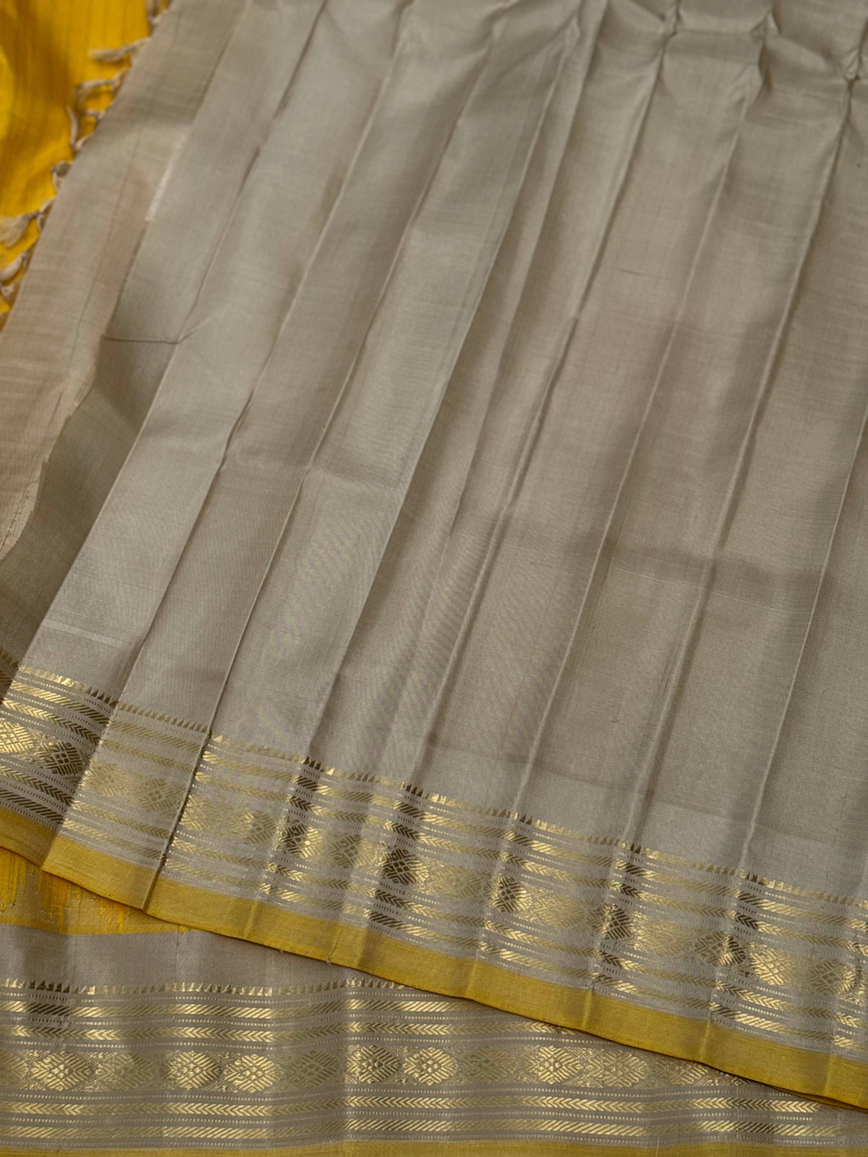 gorgeous offwhite with sunset yellow striped temple border kuttu handwoven gadwal silk saree