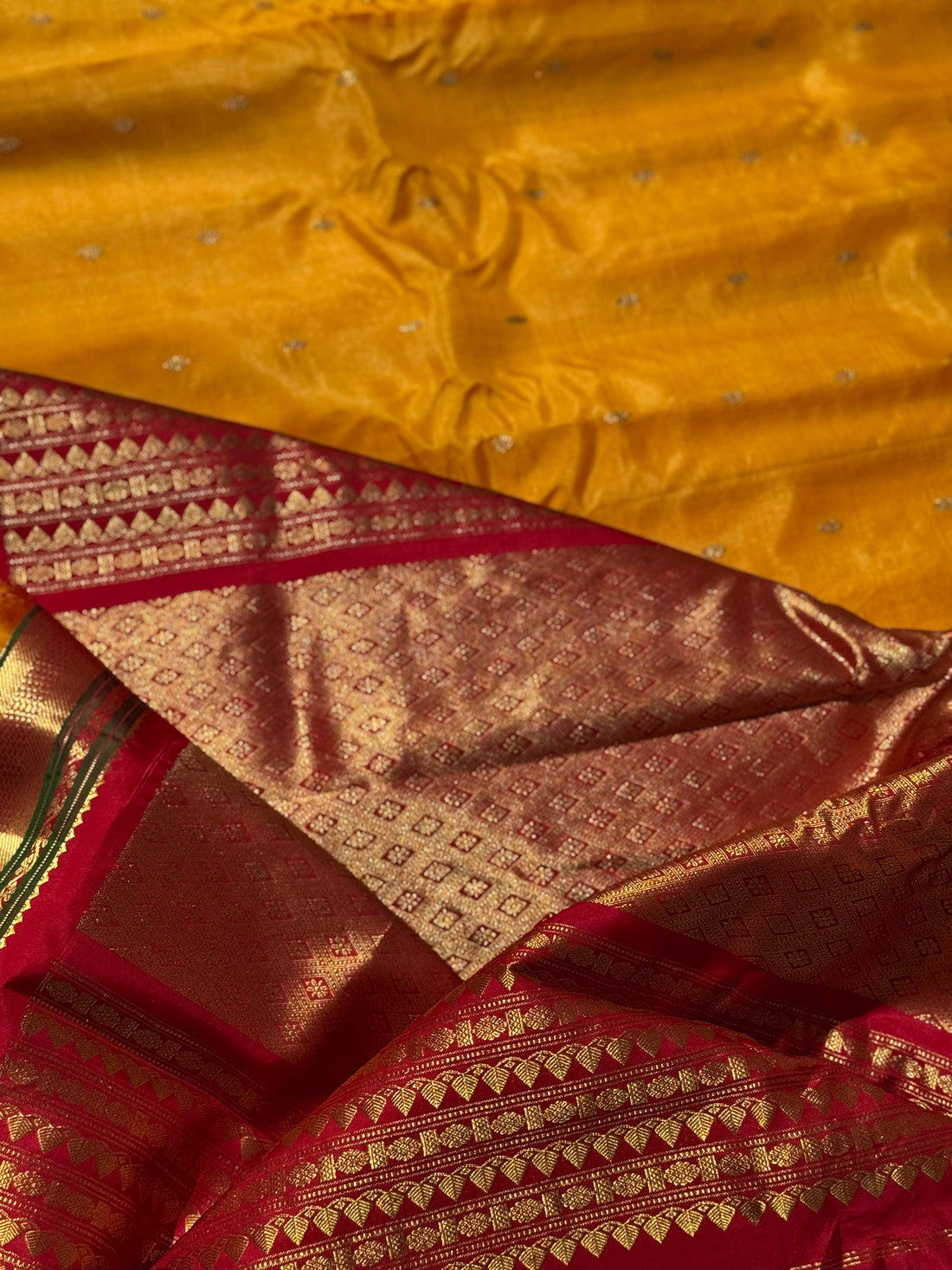 A gorgeous turmeric yellow with red temple border kuttu handwoven gadwal silk saree