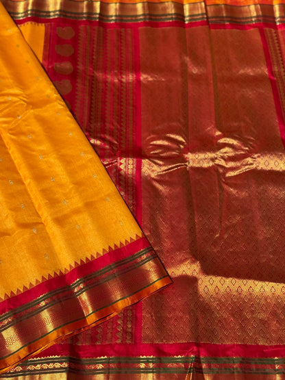 A gorgeous turmeric yellow with red temple border kuttu handwoven gadwal silk saree