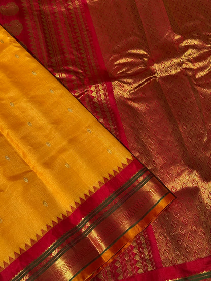 A gorgeous turmeric yellow with red temple border kuttu handwoven gadwal silk saree