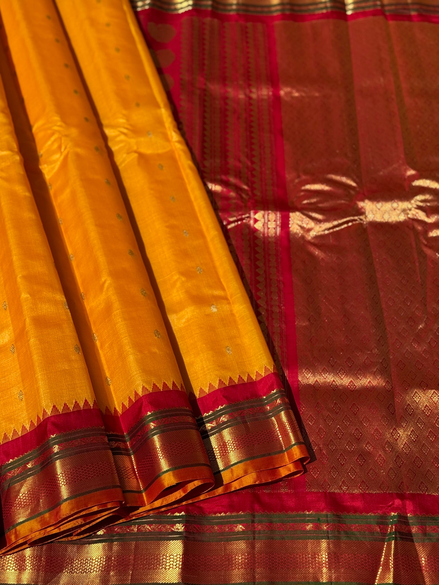 A gorgeous turmeric yellow with red temple border kuttu handwoven gadwal silk saree