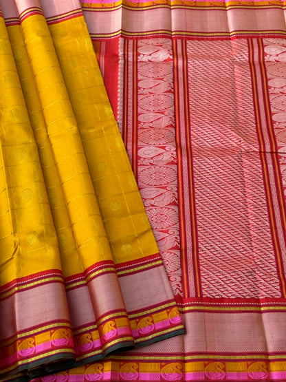 A stunner handwoven golden yellow shade with deep red Korvai kanchivaram silk saree with zari veldhari kattam