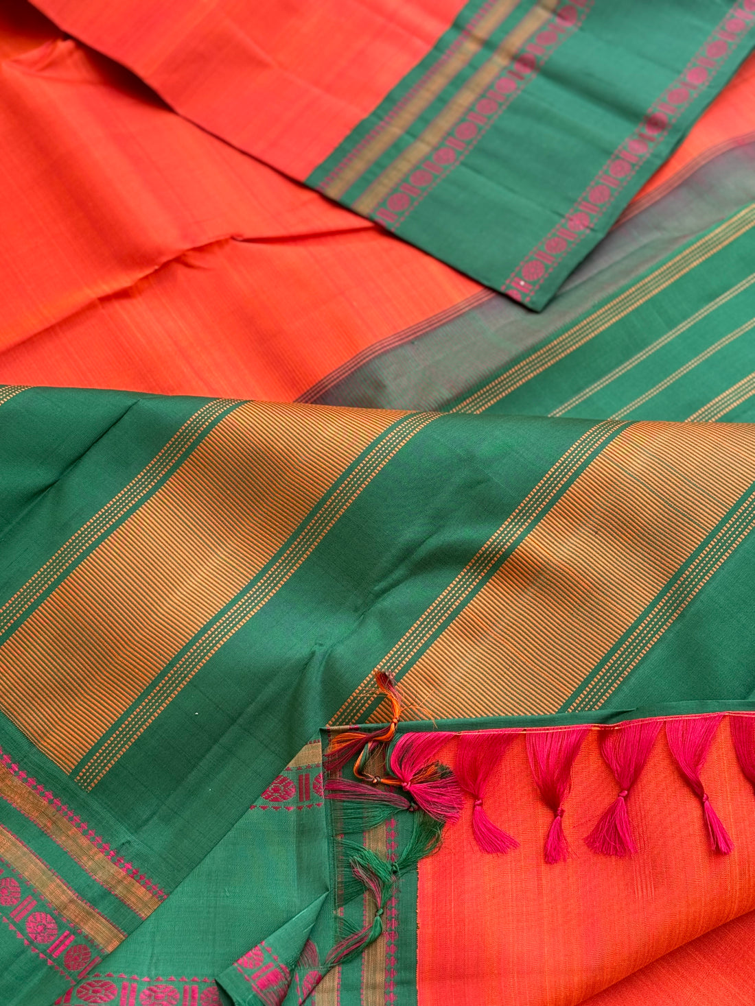 A subtle handwoven dark peach shade with green Threadwork Kai korvai kanchivaram silk saree