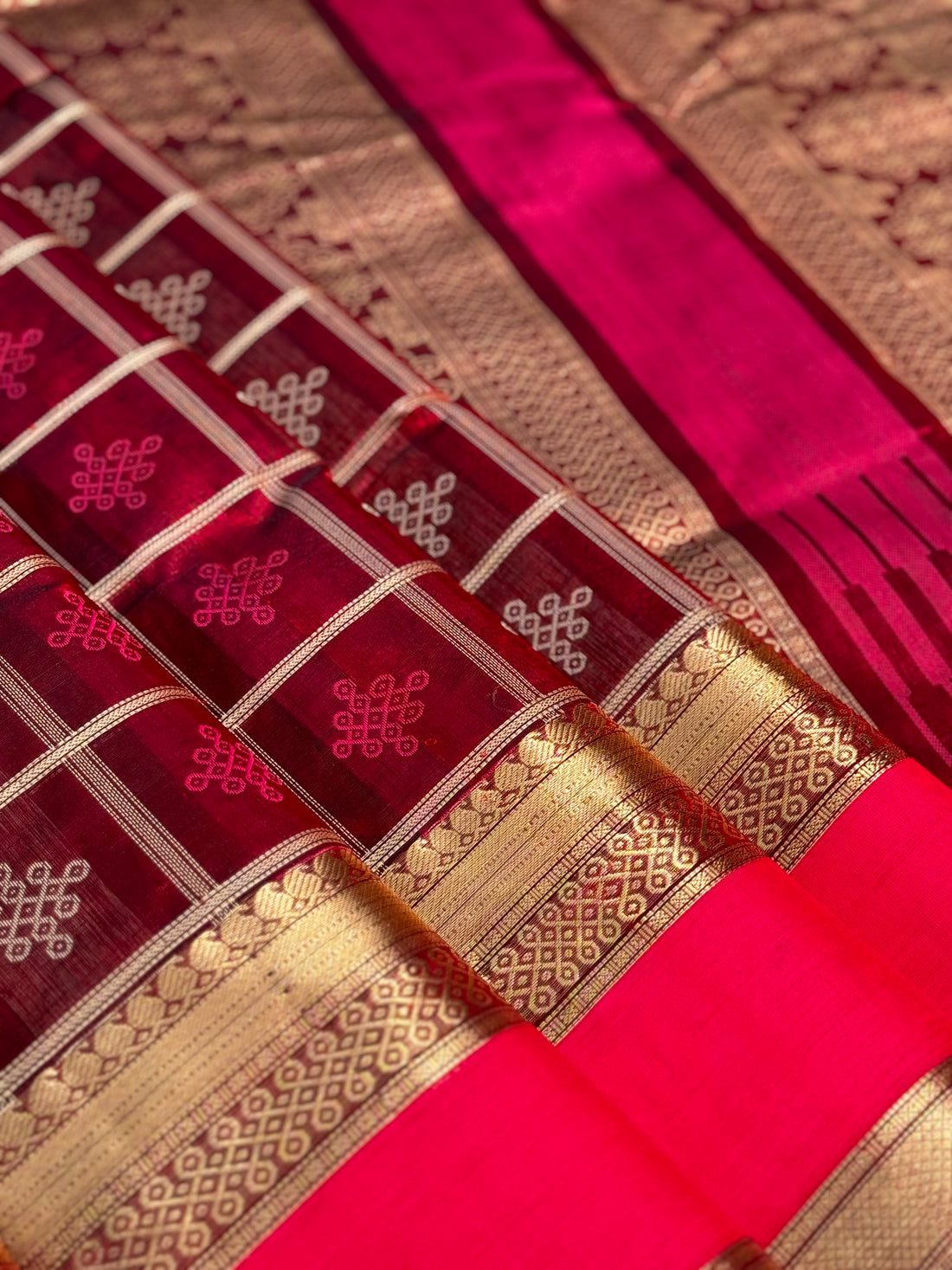 A gorgeous burgundy shade handwoven kolam buttas  silk cotton saree