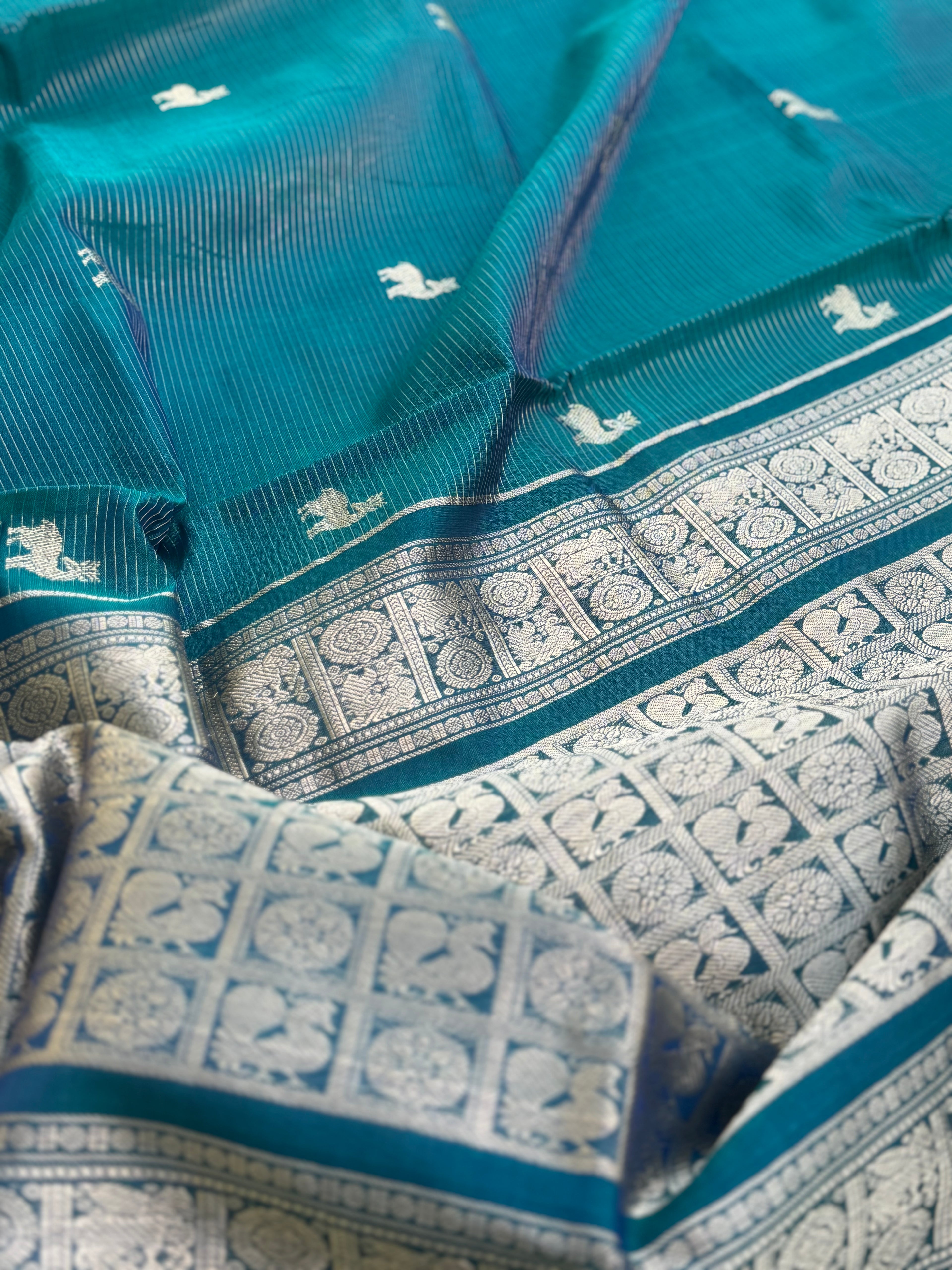 A gorgeous emerald green shade handwoven zari stripes kanchi silk cotton saree