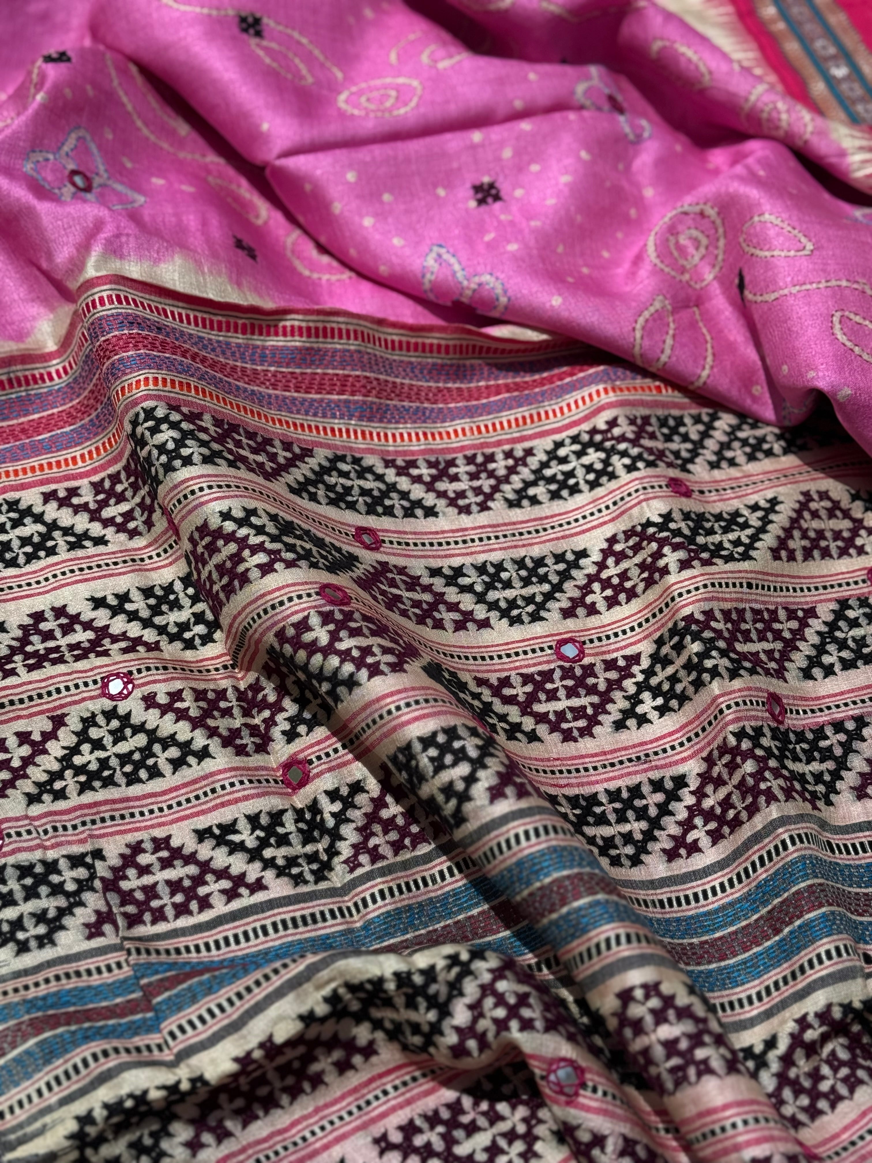 An exquisite handwoven vidharbha tussar silk saree with karvati kinar border intricately tie dyed with pink bhandhej and kutch hand embroidered