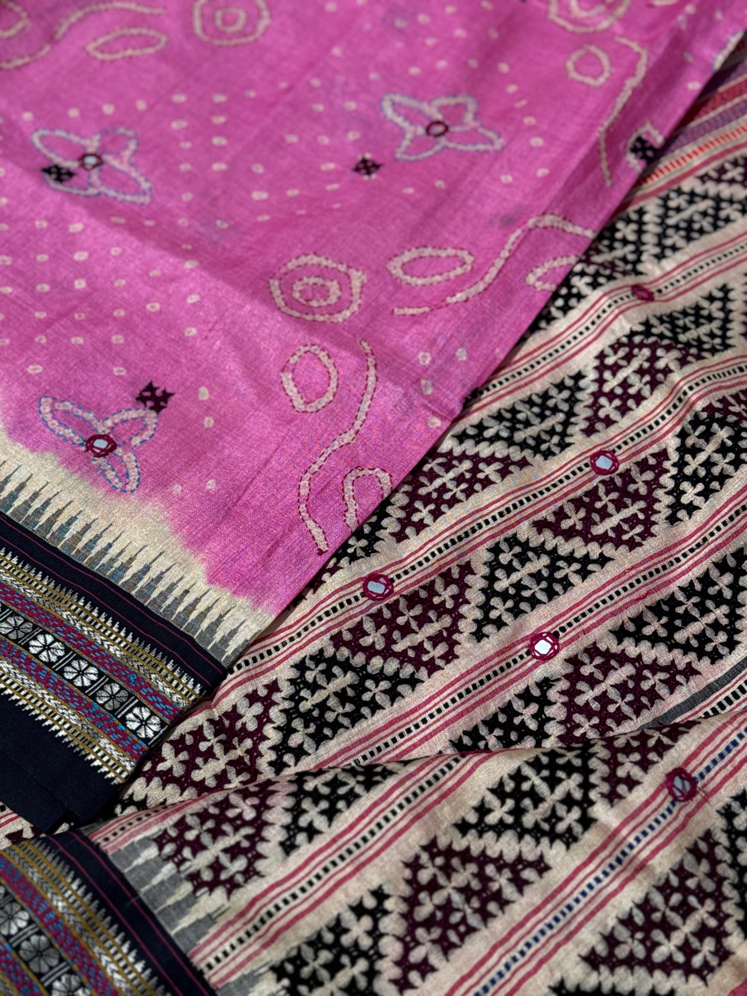 An exquisite handwoven vidharbha tussar silk saree with karvati kinar border intricately tie dyed with pink bhandhej and kutch hand embroidered