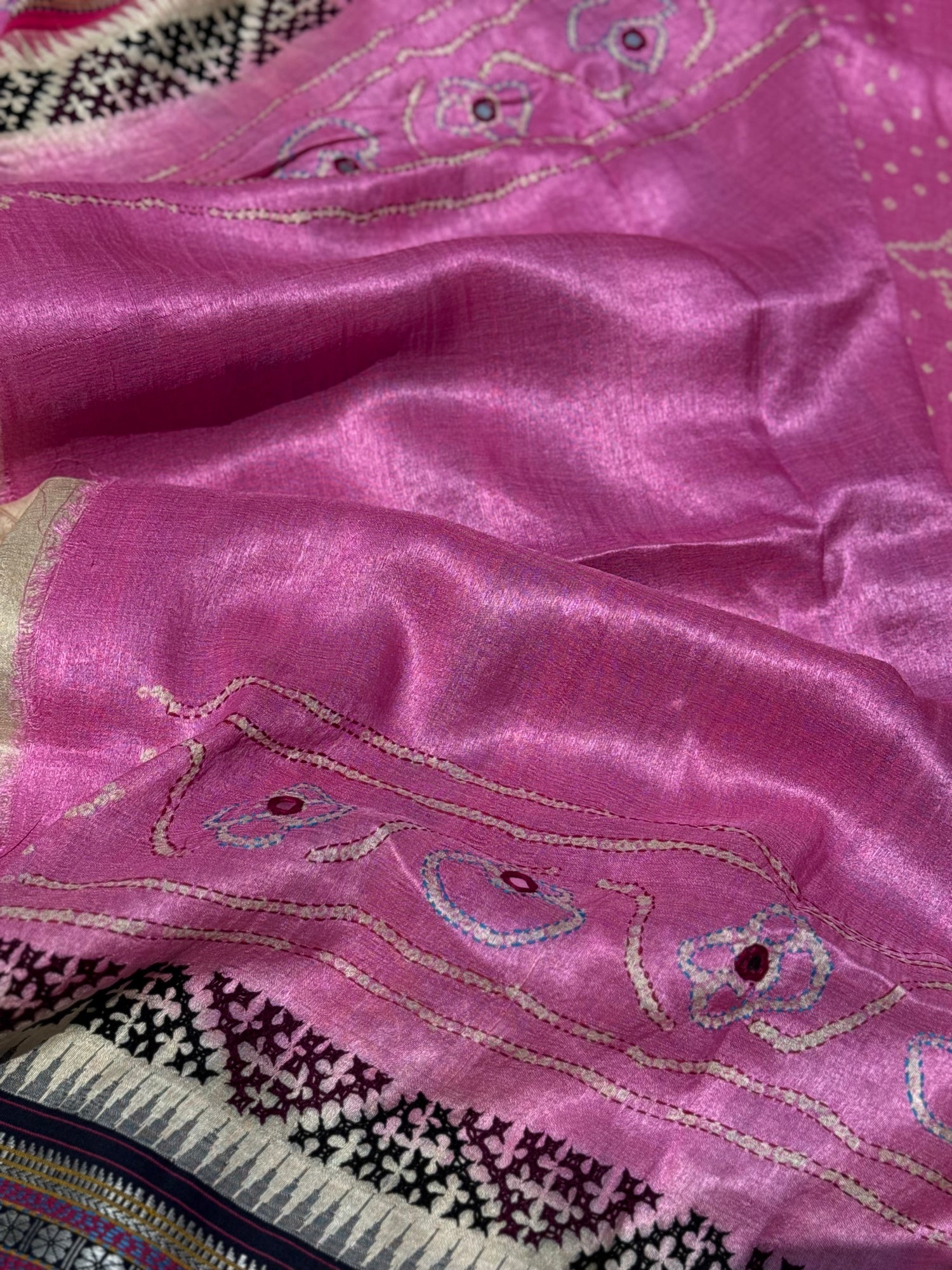 An exquisite handwoven vidharbha tussar silk saree with karvati kinar border intricately tie dyed with pink bhandhej and kutch hand embroidered