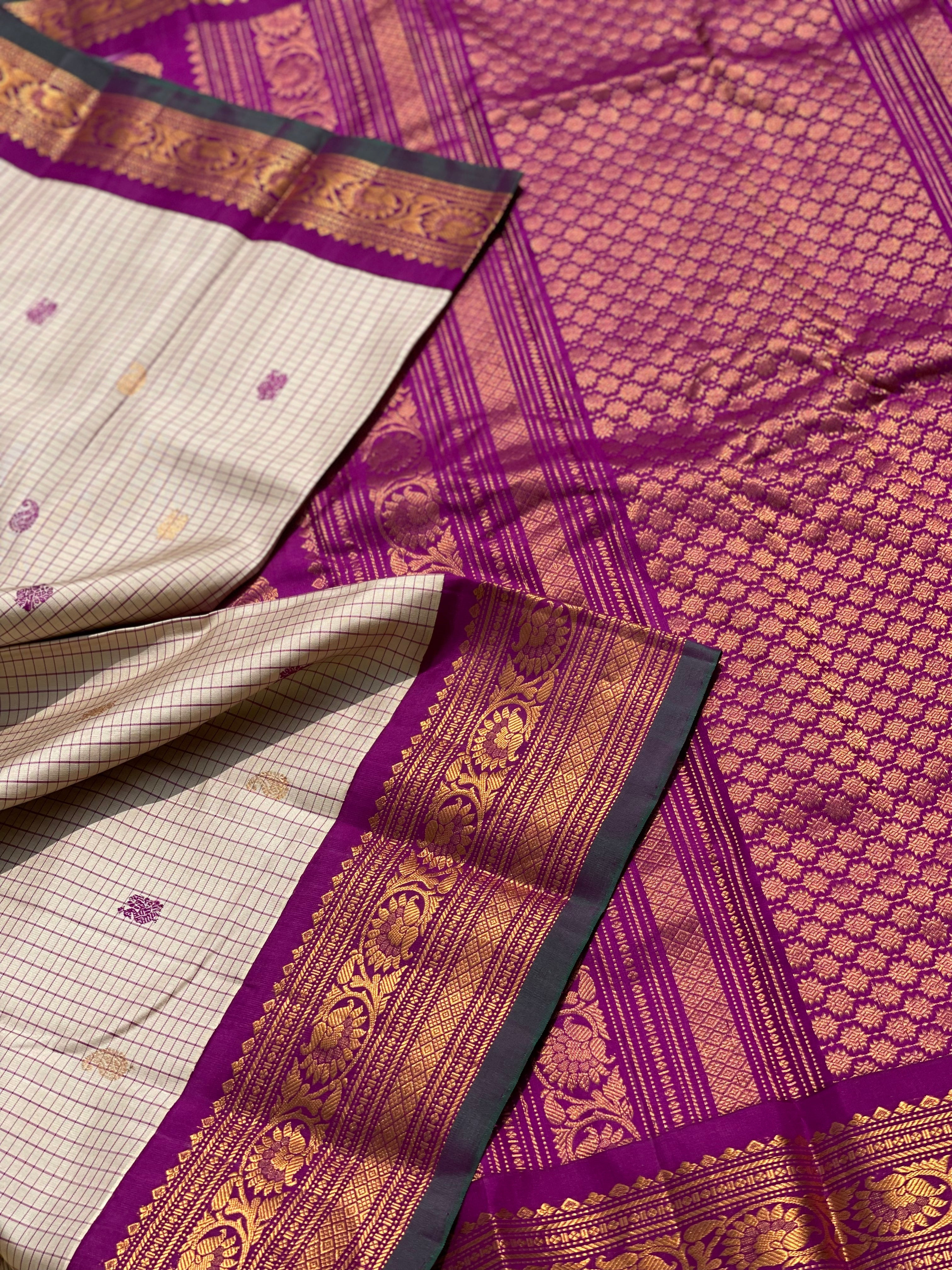 An elegant checks Pearl white with purple Gadwal silk saree