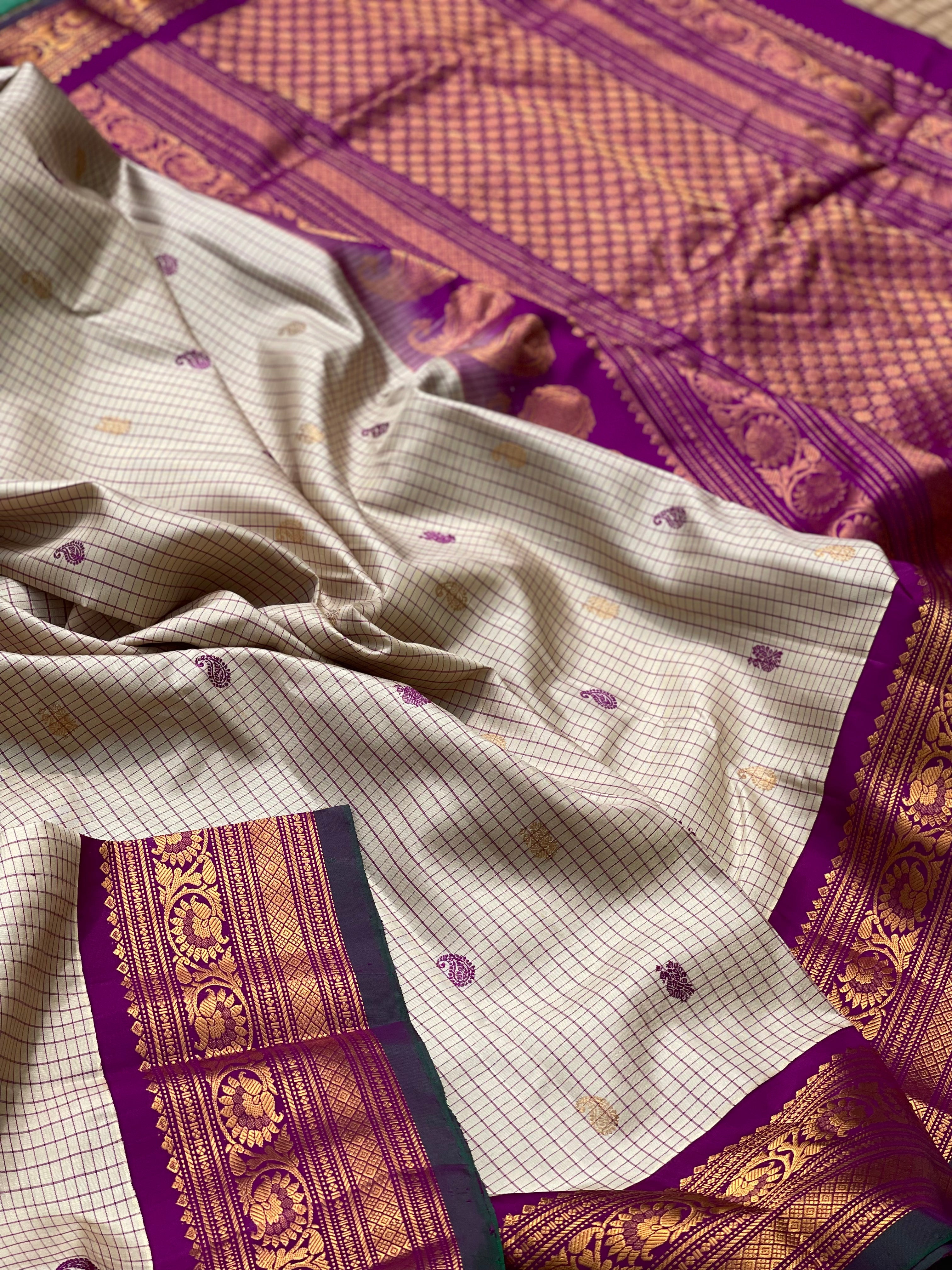 An elegant checks Pearl white with purple Gadwal silk saree