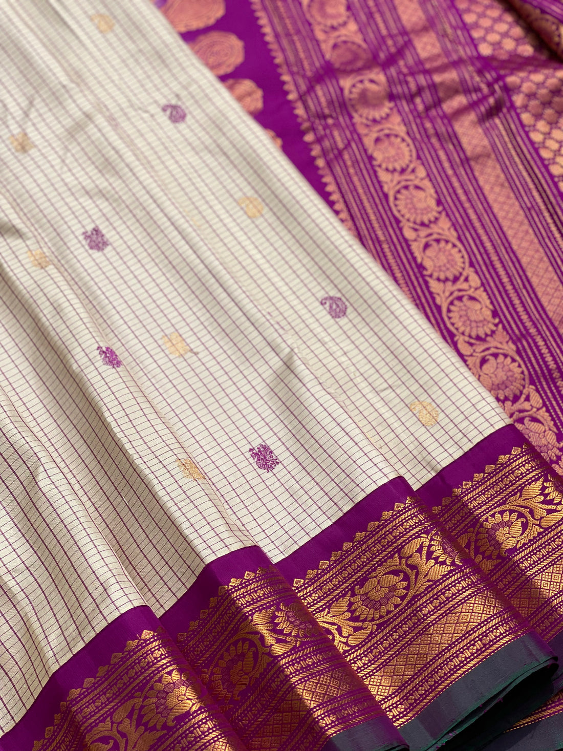 An elegant checks Pearl white with purple Gadwal silk saree