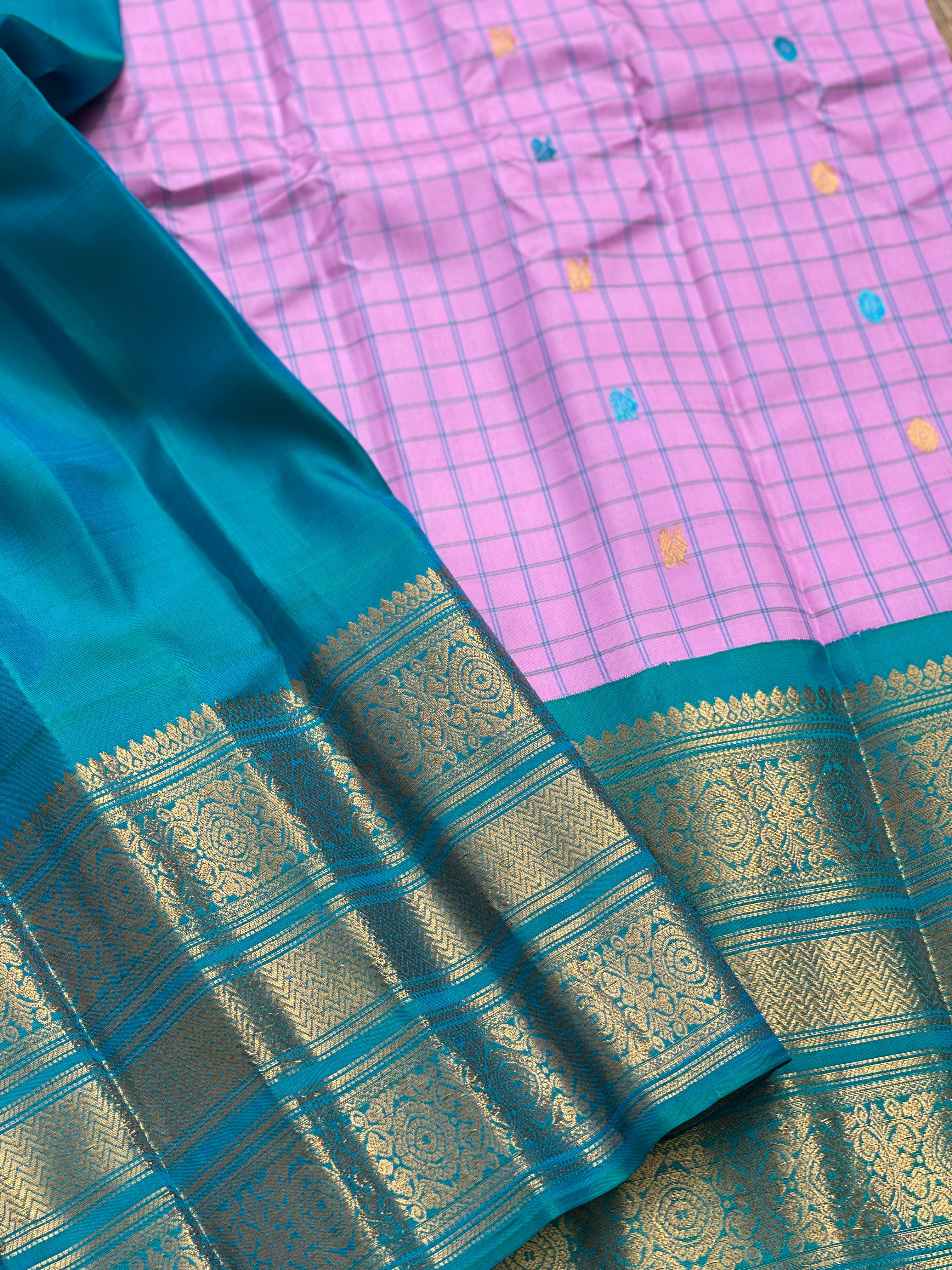 An Elegant baby pink Gadwal silk with Peacock green Kanchi turning border