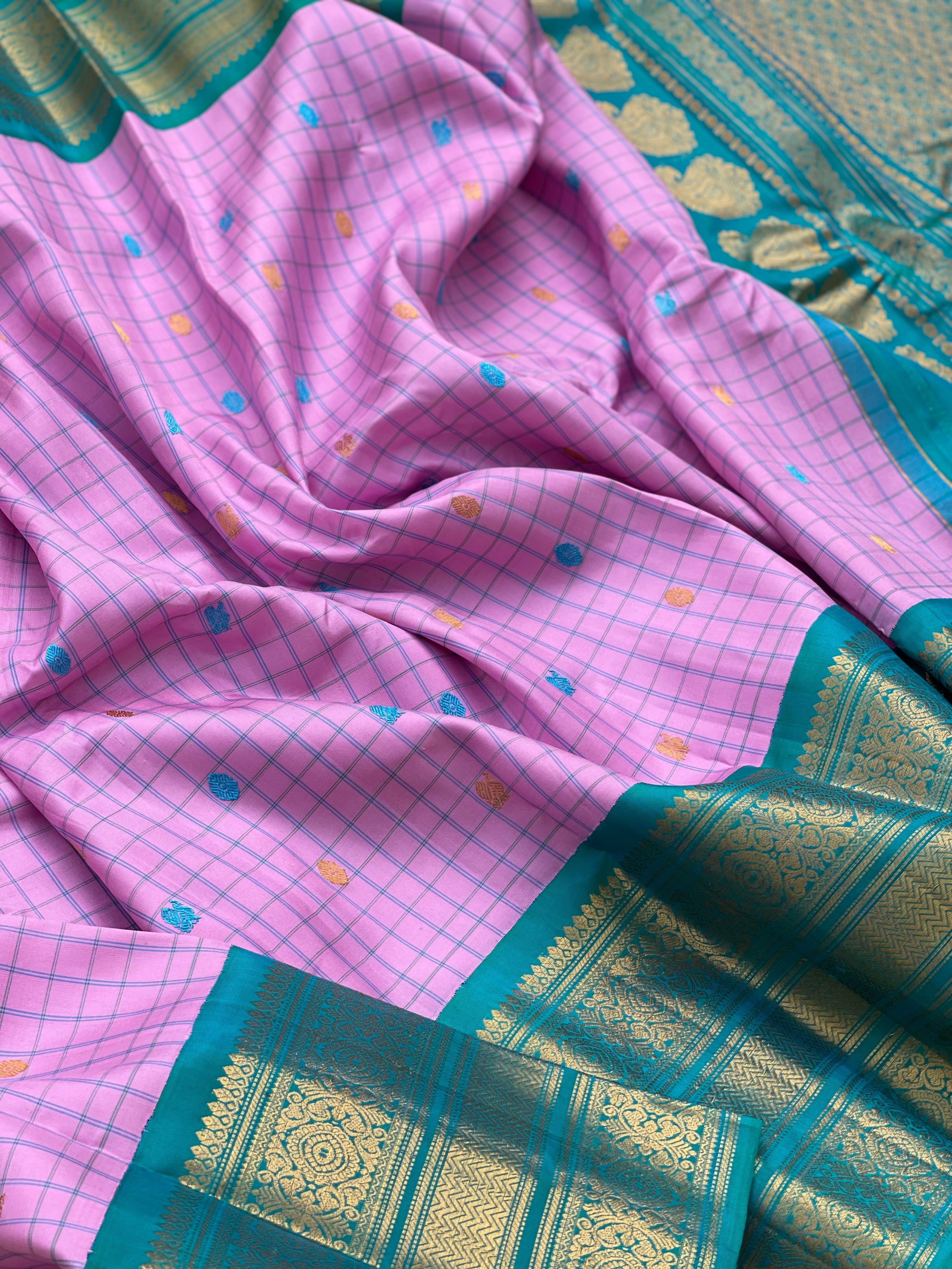 An Elegant baby pink Gadwal silk with Peacock green Kanchi turning border