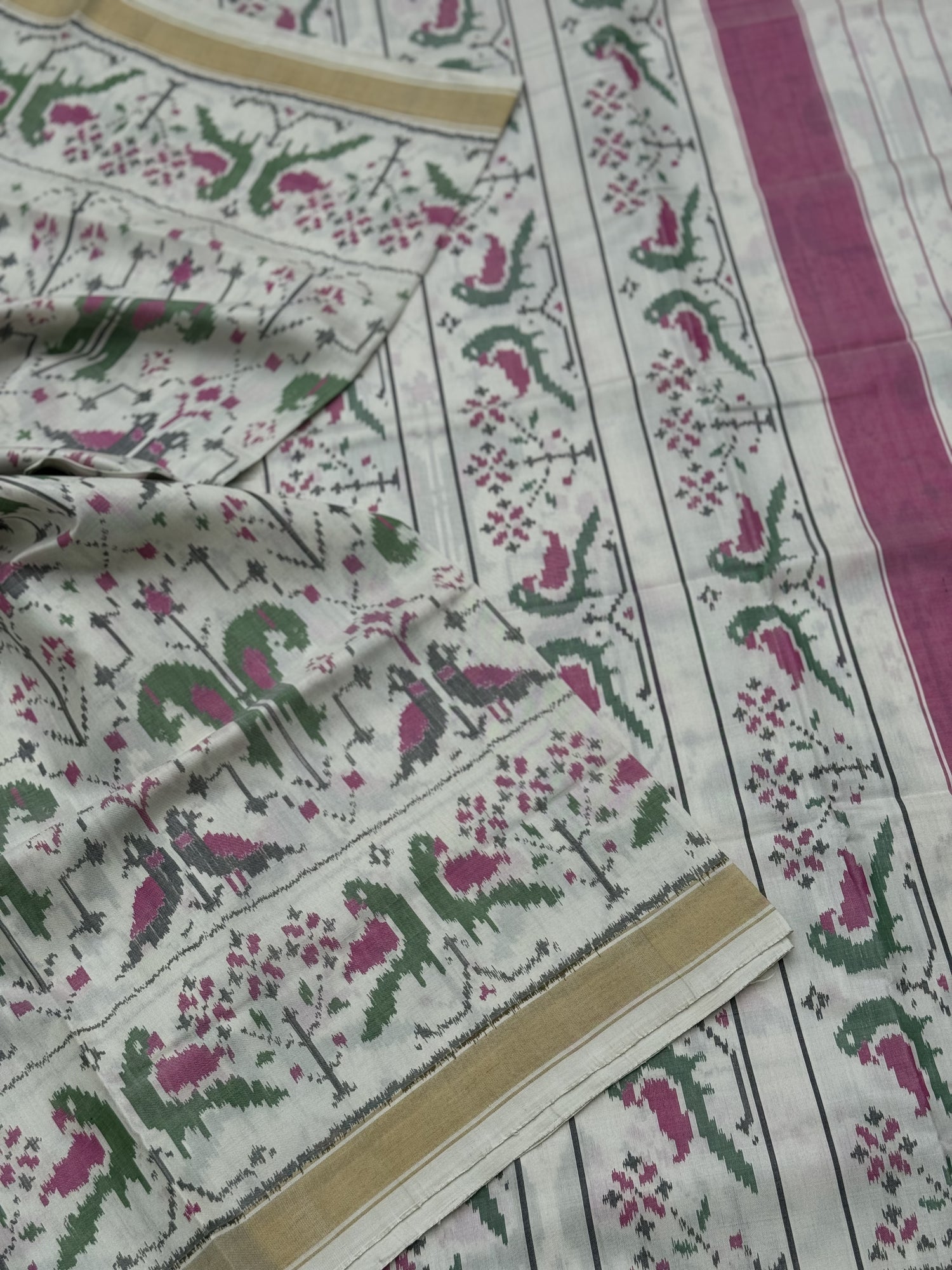 A gorgeous Ivory white single ikkat patola silk SAREE with twin parrot motifs