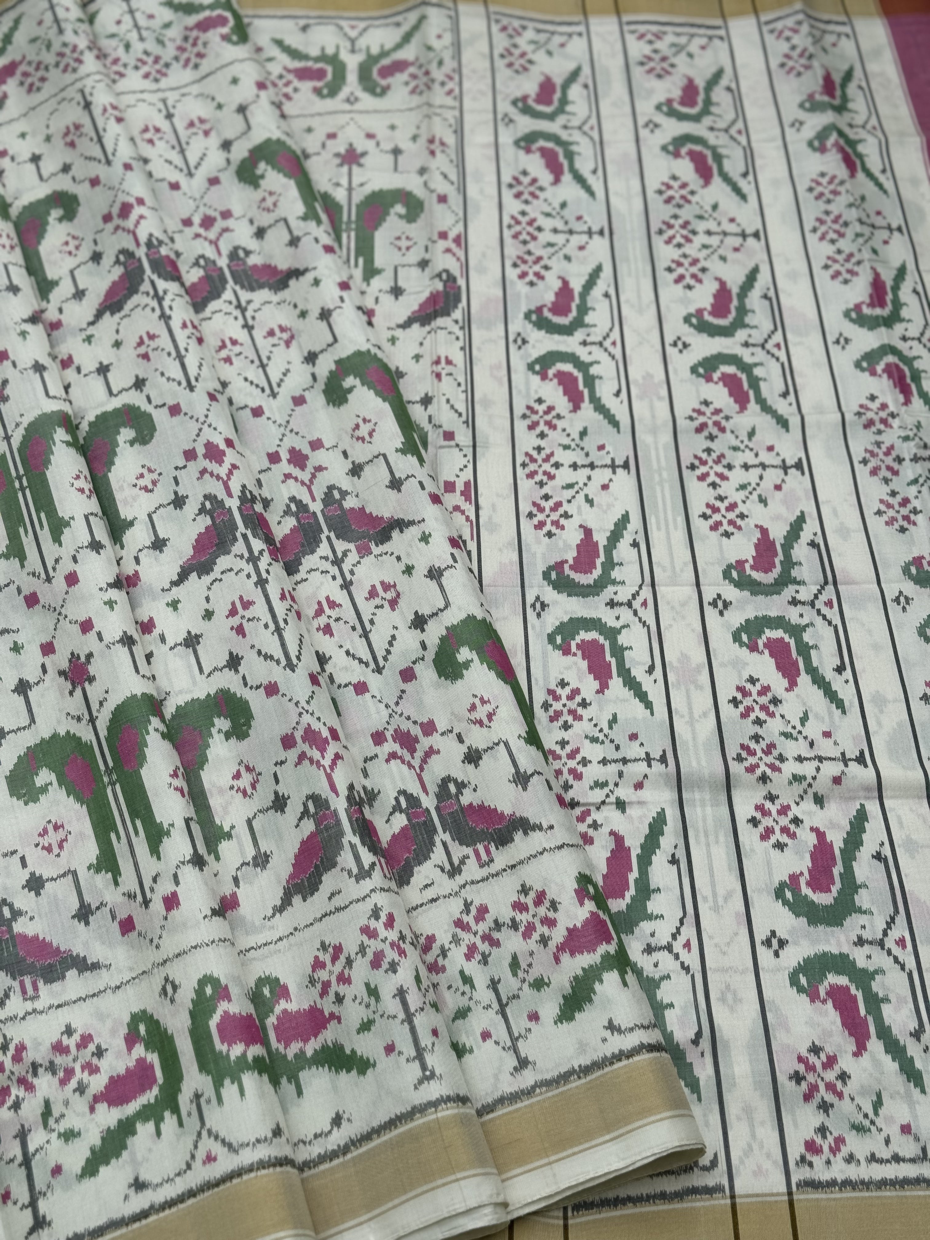 A gorgeous Ivory white single ikkat patola silk SAREE with twin parrot motifs