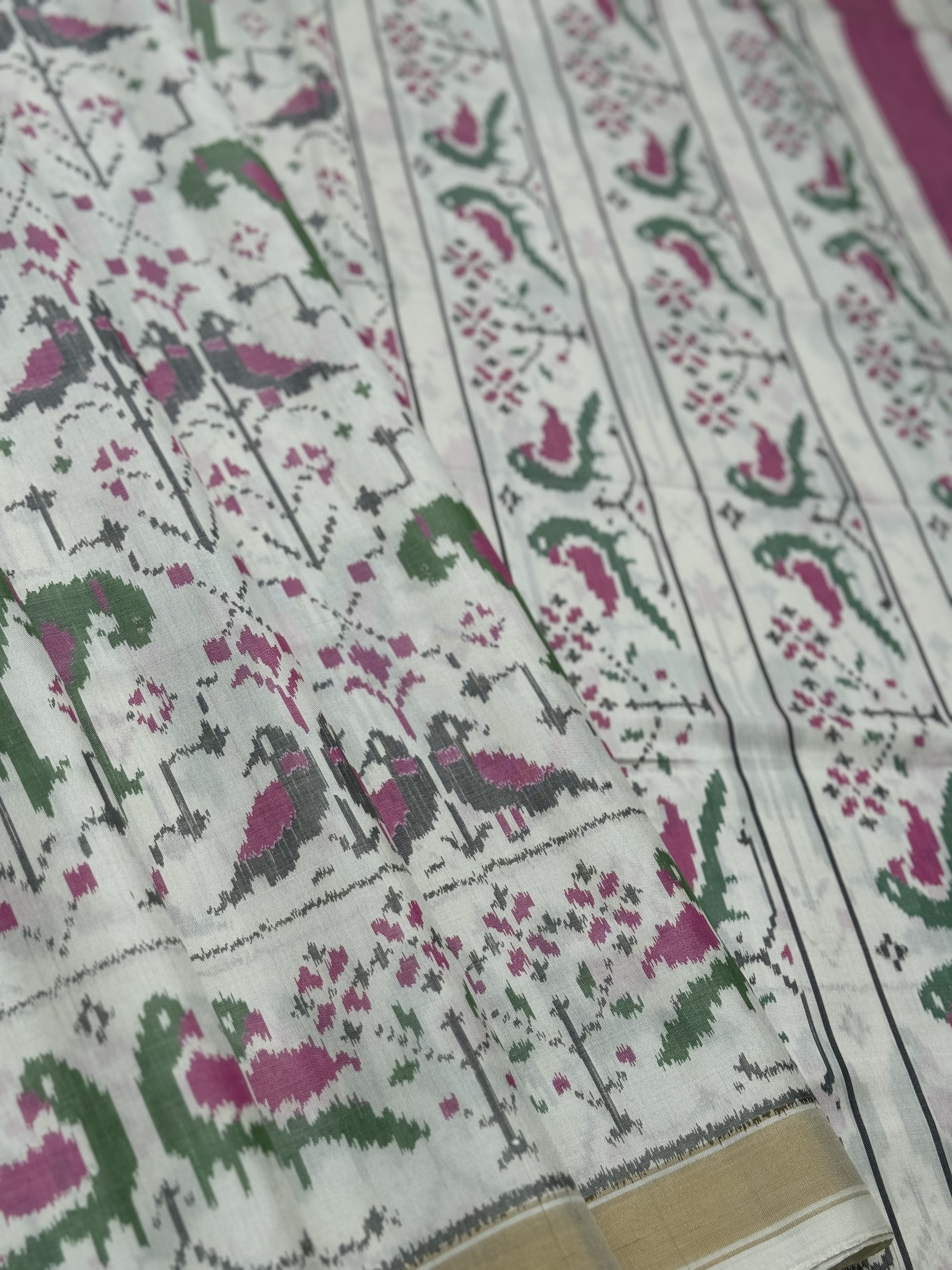 A gorgeous Ivory white single ikkat patola silk SAREE with twin parrot motifs