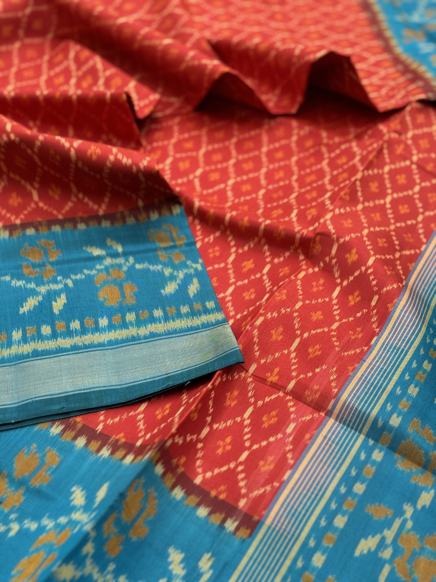 A gorgeous burnt Orange with teal single ikkat patola silk saree