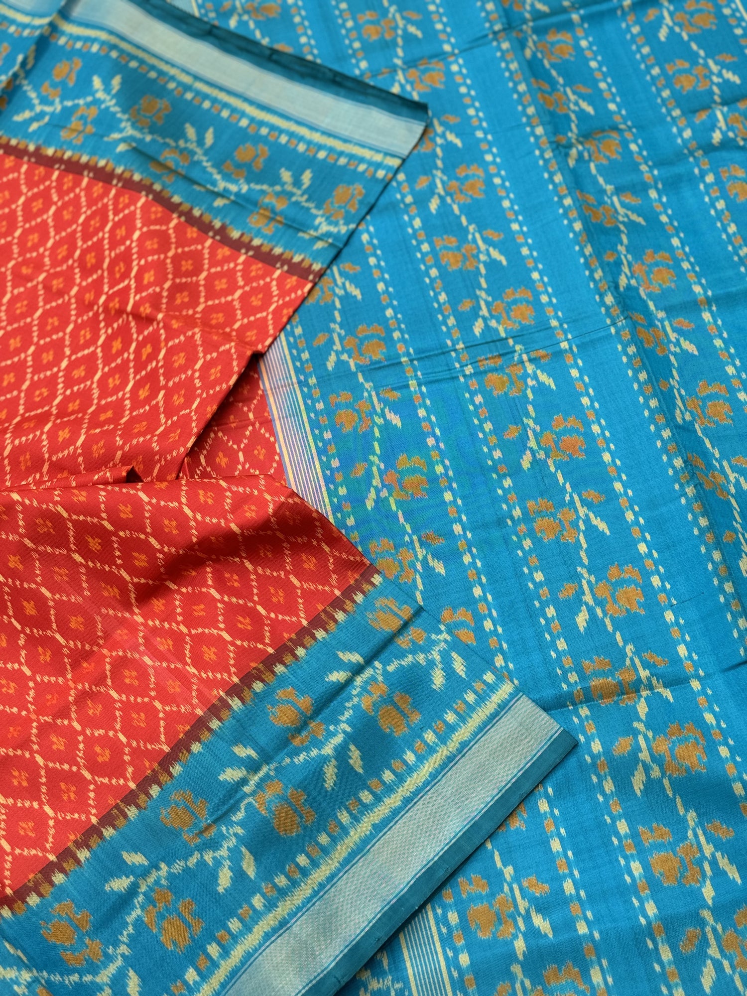 A gorgeous burnt Orange with teal single ikkat patola silk saree