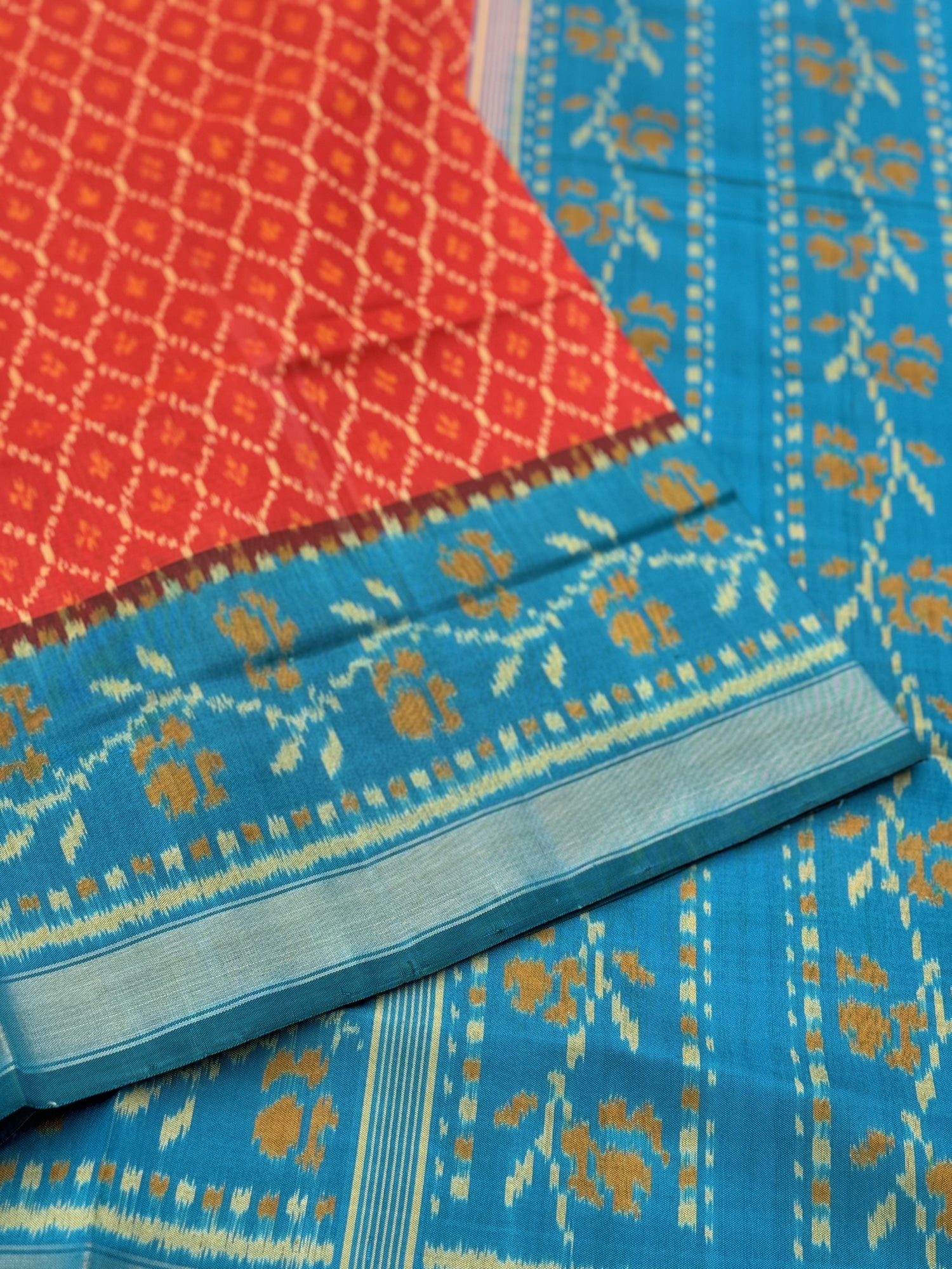 A gorgeous burnt Orange with teal single ikkat patola silk saree