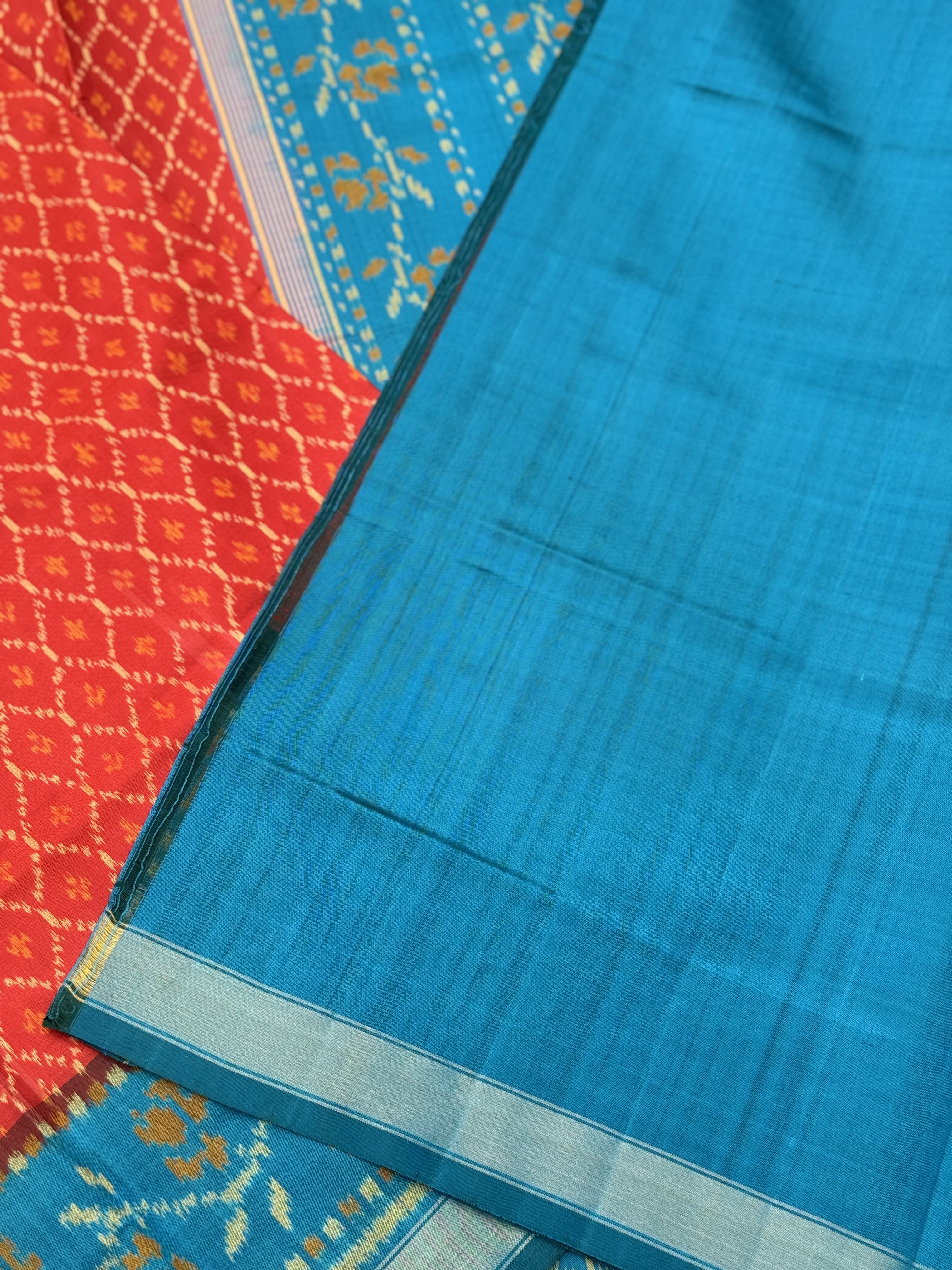 A gorgeous burnt Orange with teal single ikkat patola silk saree