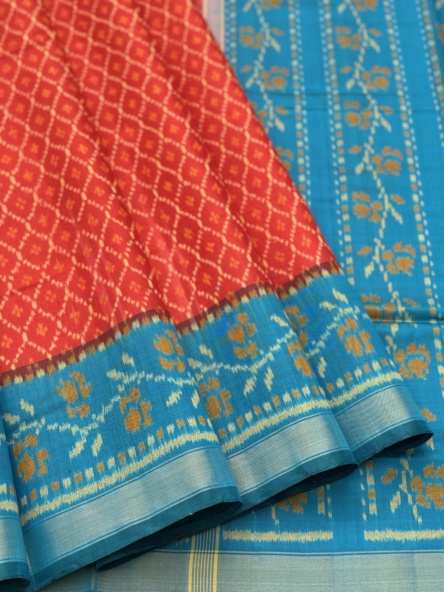 A gorgeous burnt Orange with teal single ikkat patola silk saree